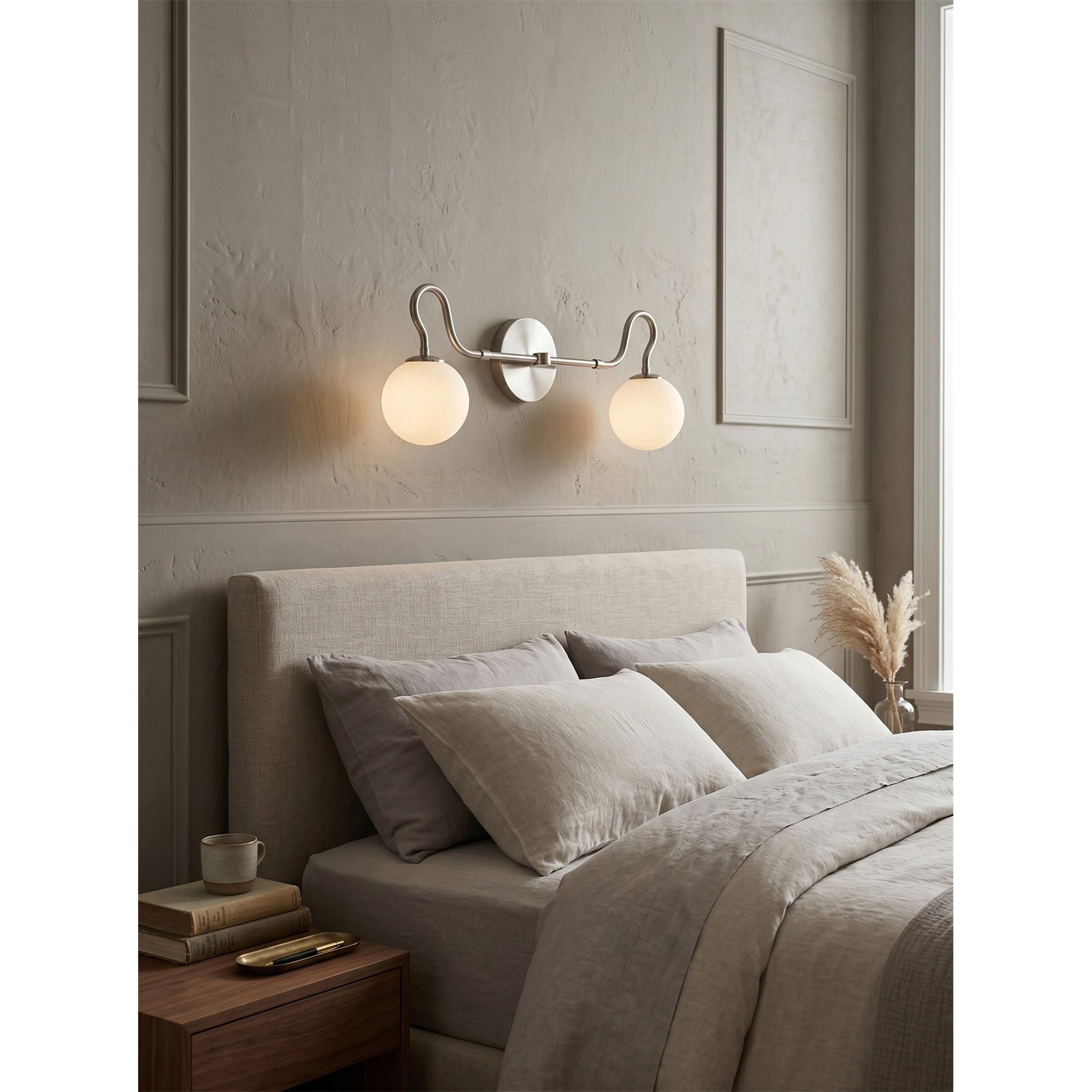 The Floren sconce in black providing ambient light in a stylish powder room.