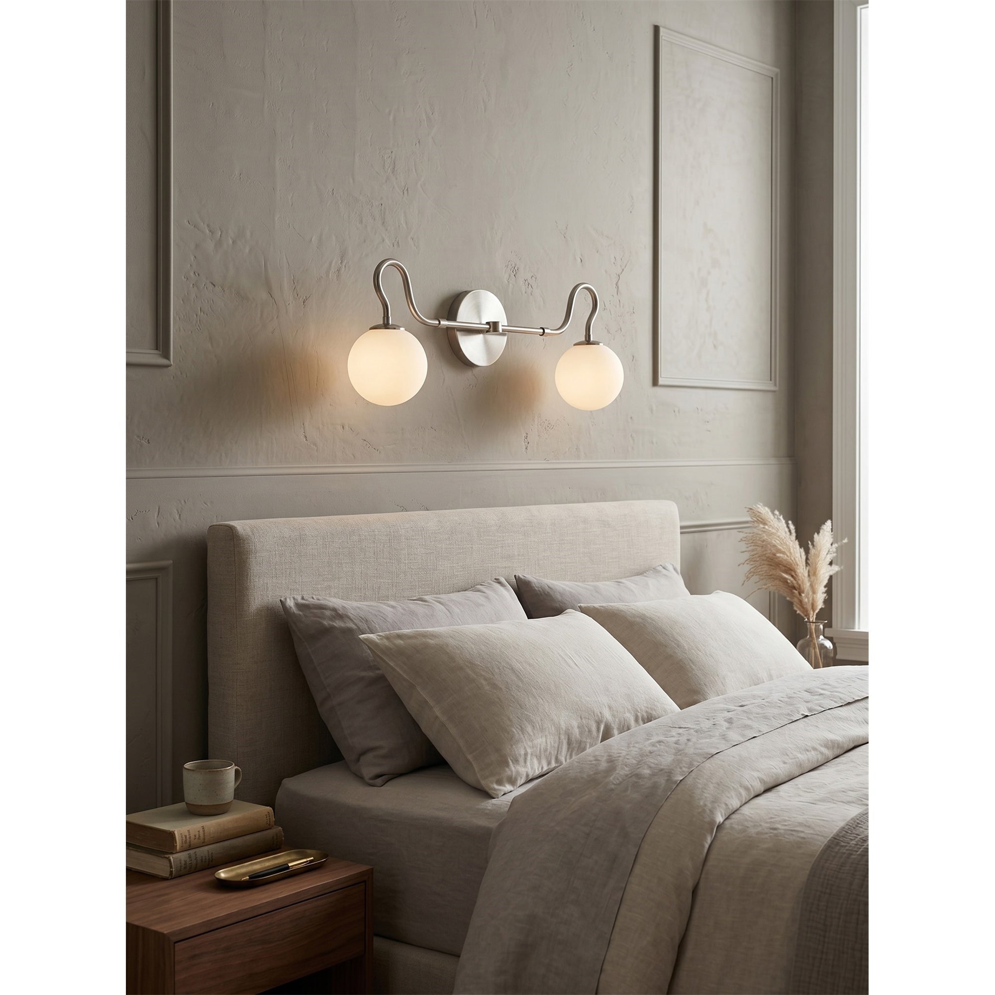 The Floren sconce in black providing ambient light in a stylish powder room.