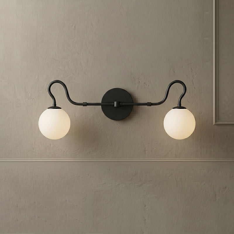The Floren sconce illuminated, casting a warm glow.