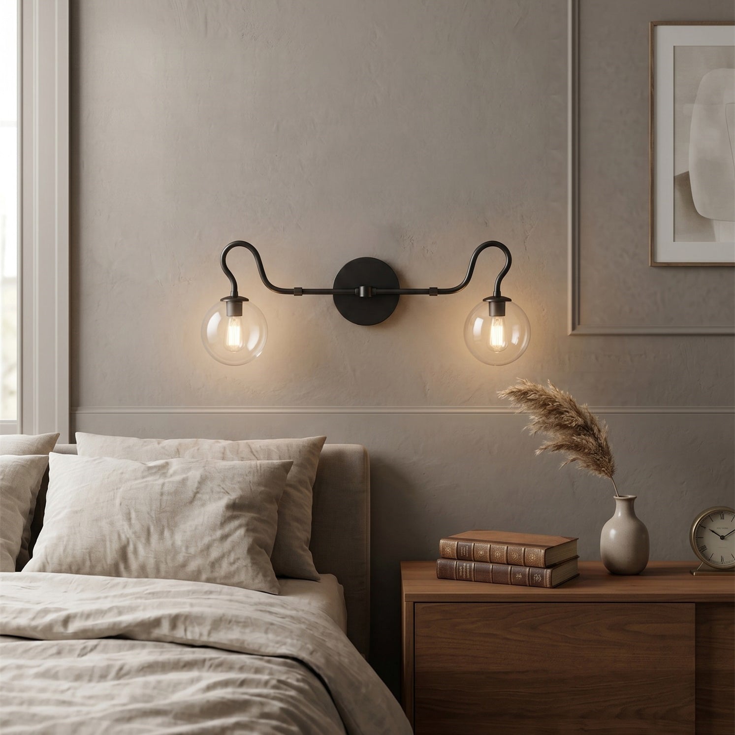 Close-up view of the brass finish and symmetrical curlicue arm of the Floren sconce.