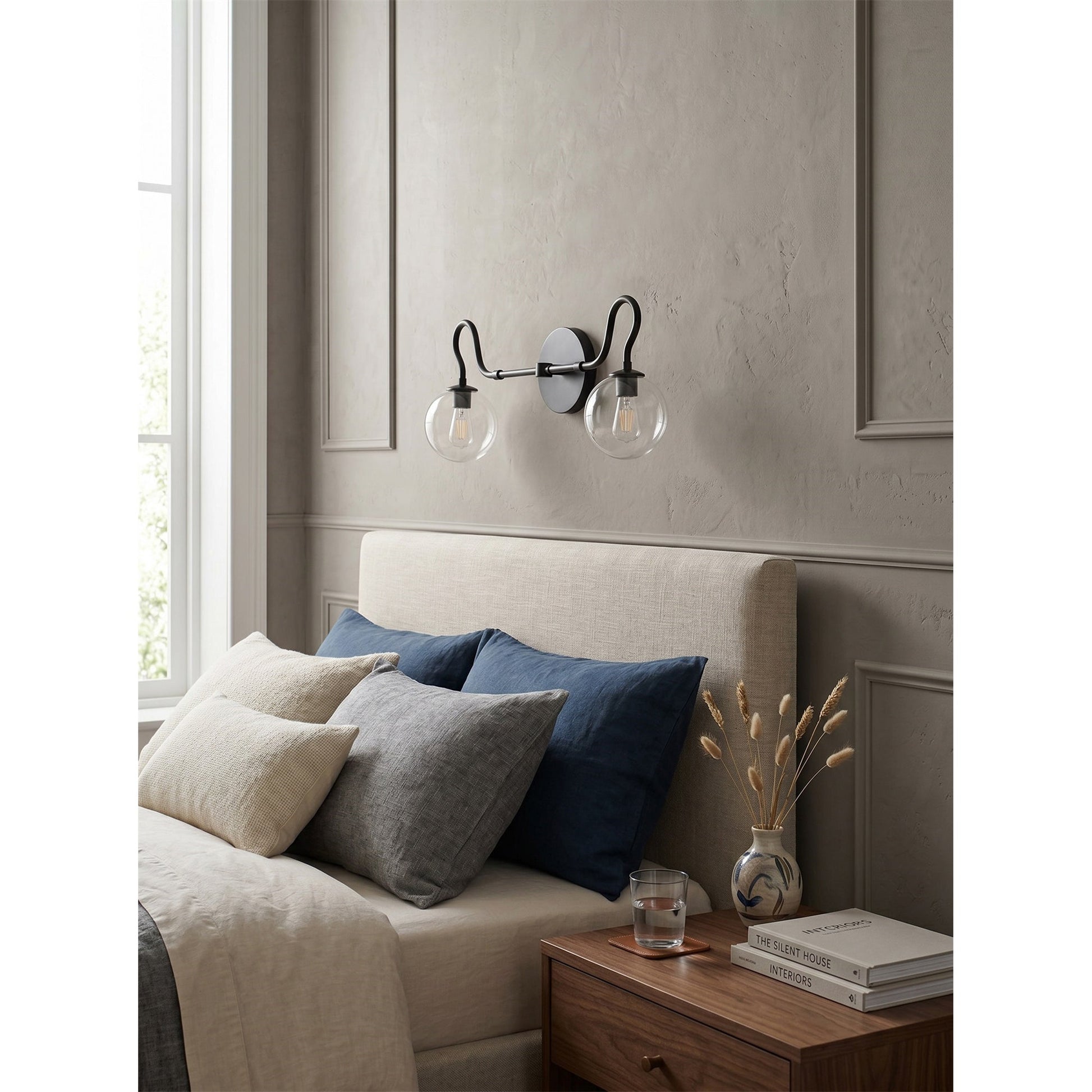 Detailed shot of the clear glass globe shade on the Floren sconce.