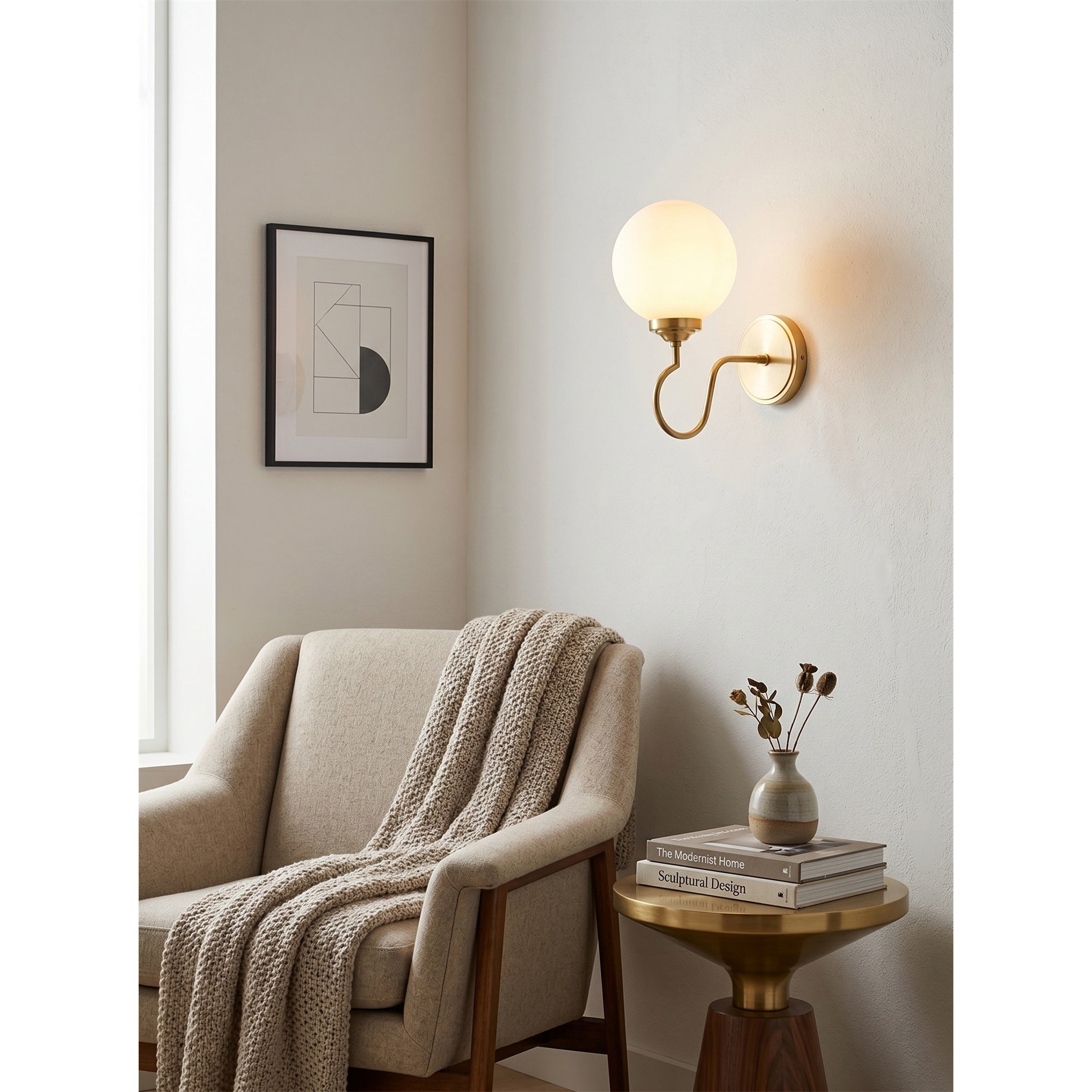 Close-up of the white glass globe shade on the Floren Wall Sconce.