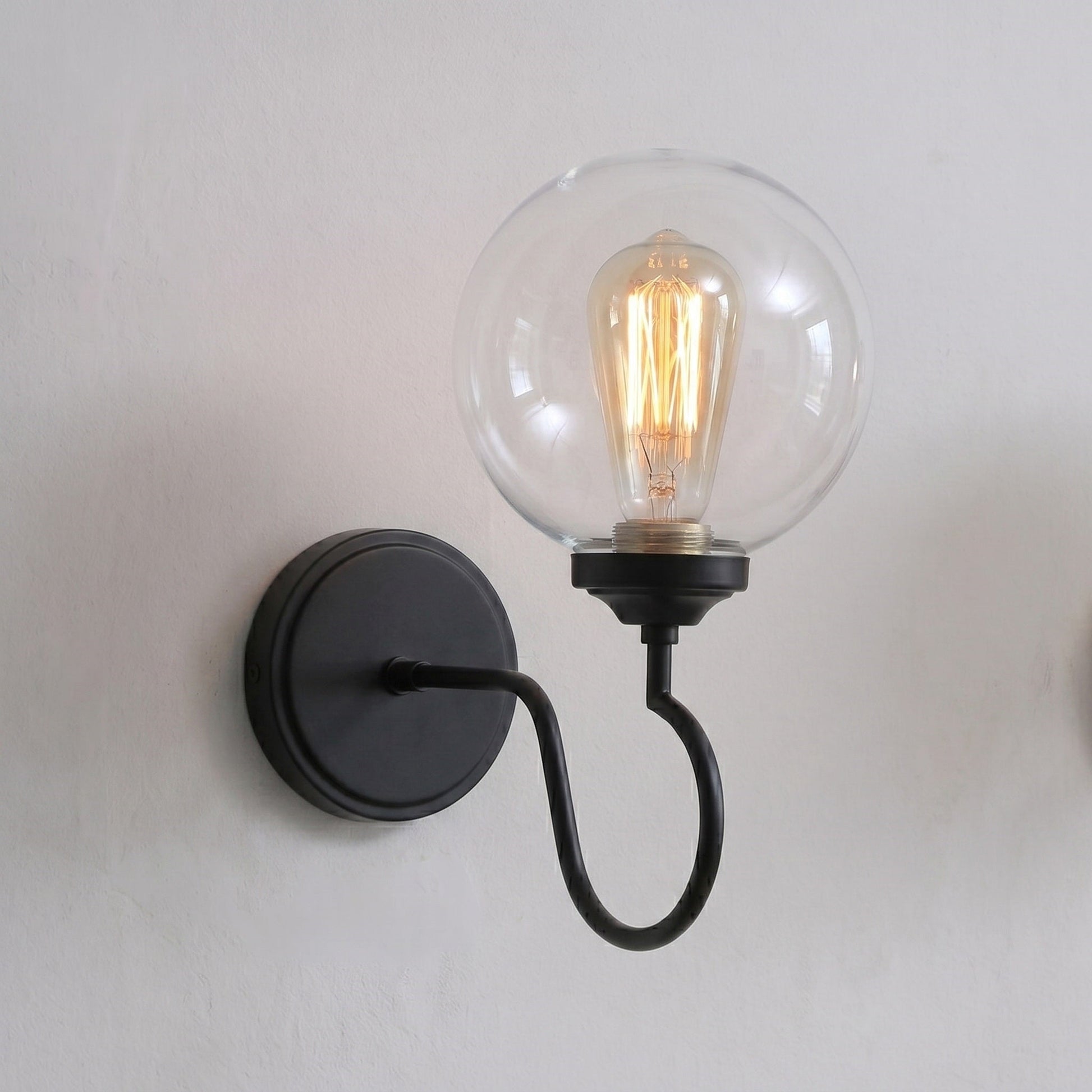 The Floren Wall Sconce used as a vanity light in a powder room.