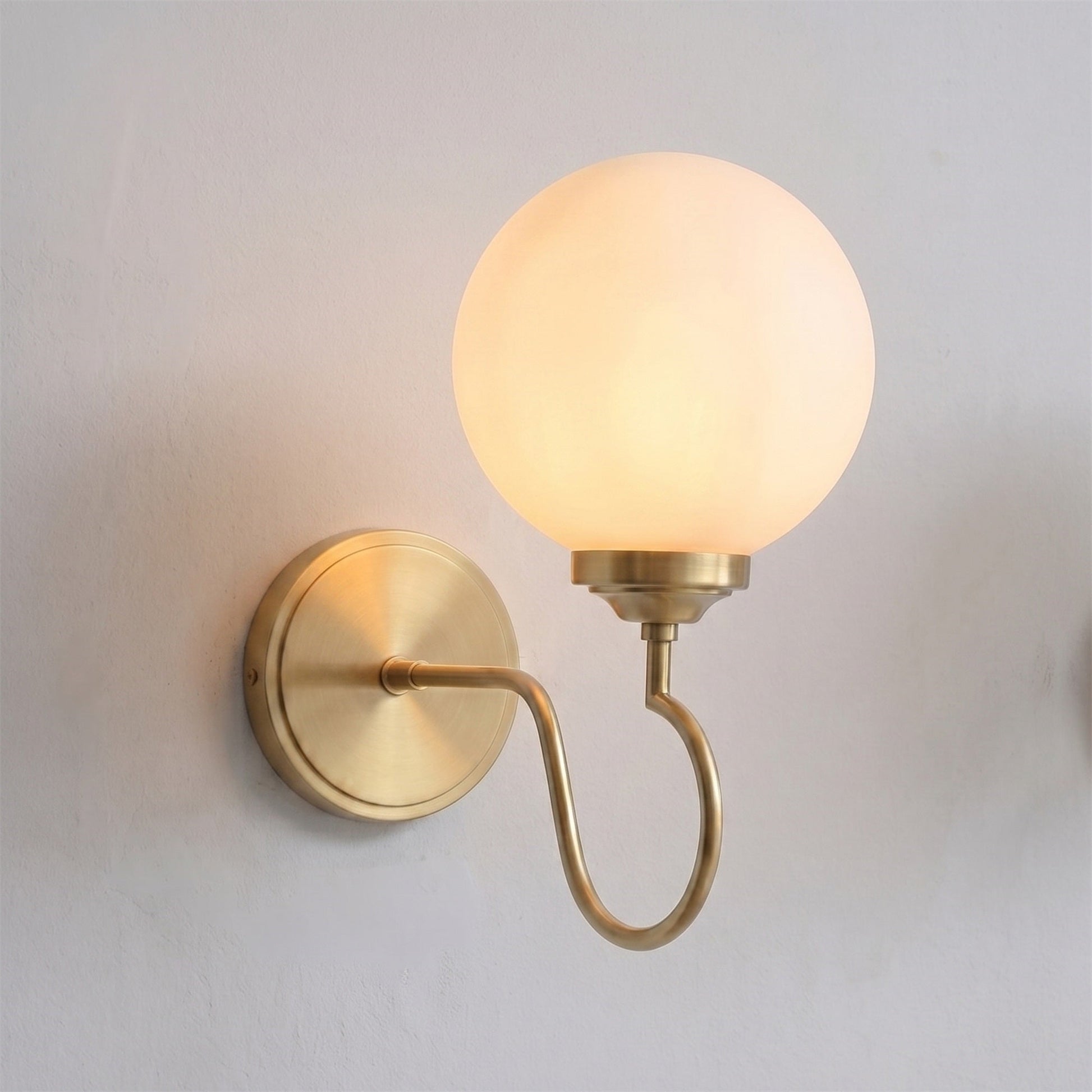 Floren Wall Sconce in nickel finish with a clear glass globe.