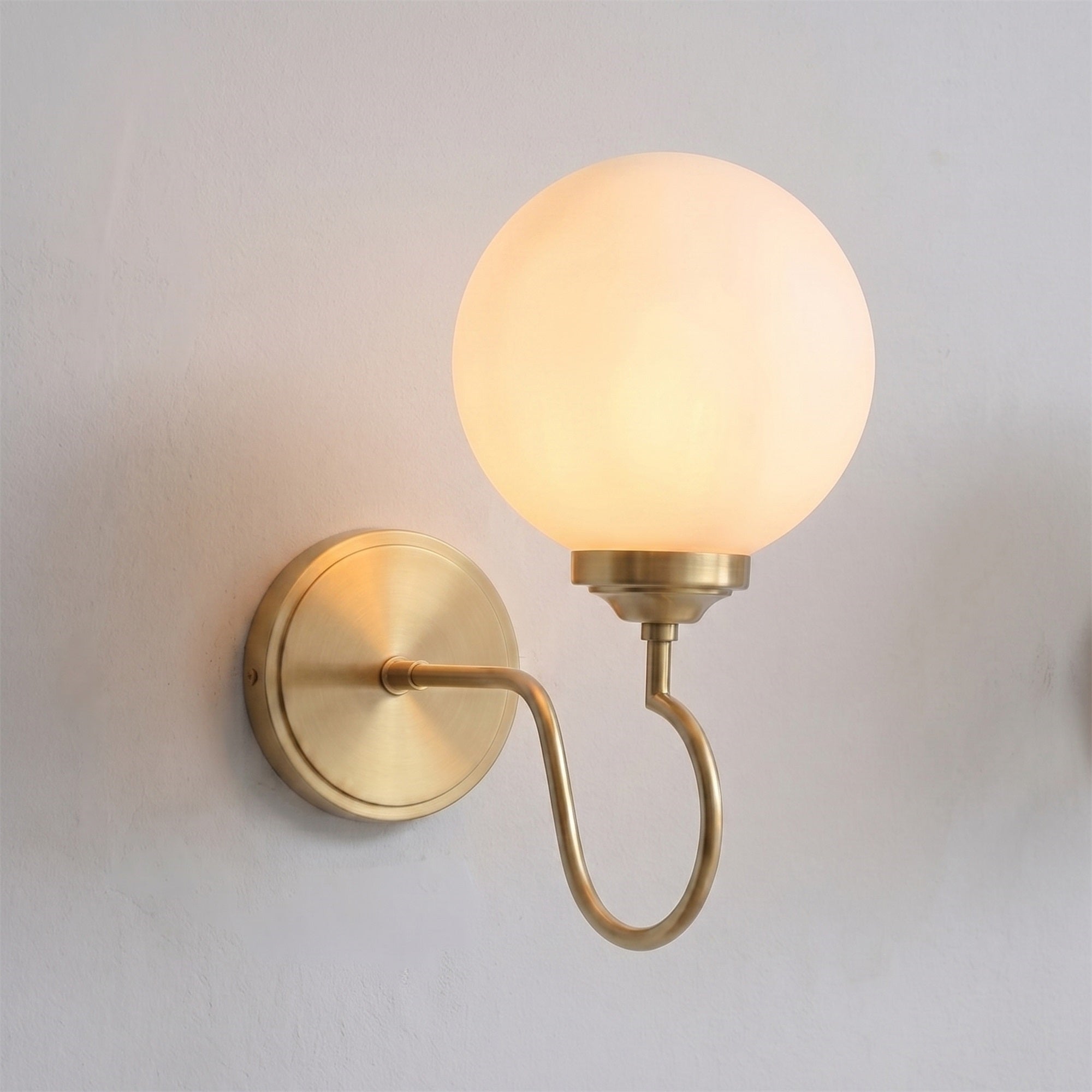 Floren Wall Sconce in nickel finish with a clear glass globe.