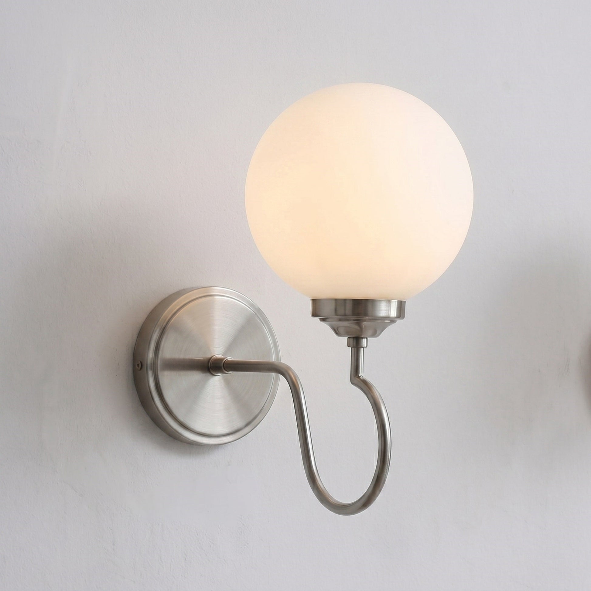Floren Wall Sconce in black finish, viewed from a low angle.