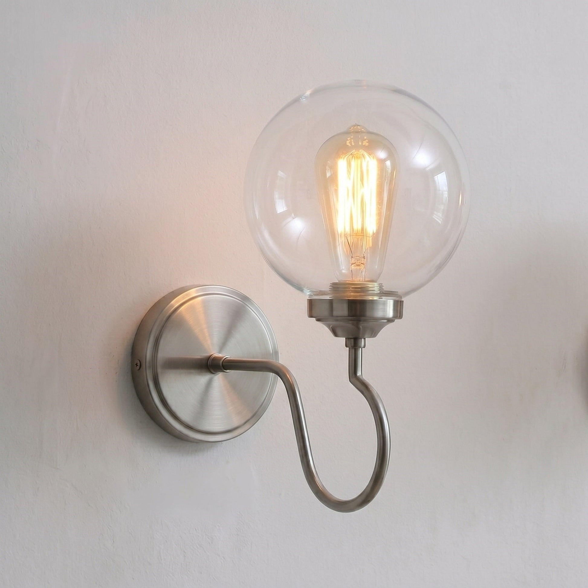 Floren Wall Sconce in nickel finish in a minimalist entryway.