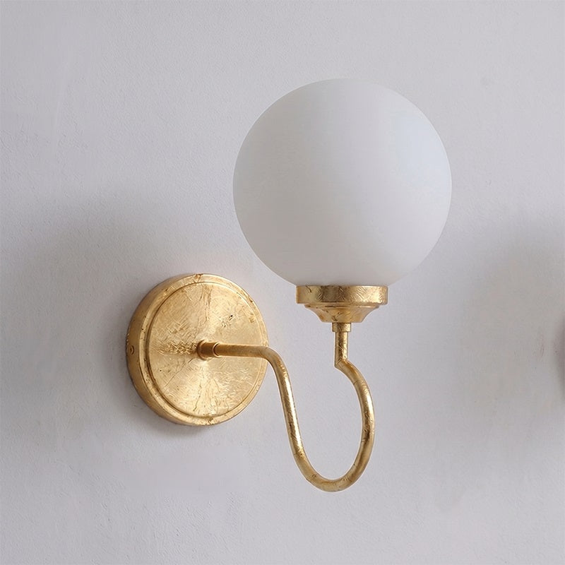The elegant silhouette of the Floren Wall Sconce in brass.