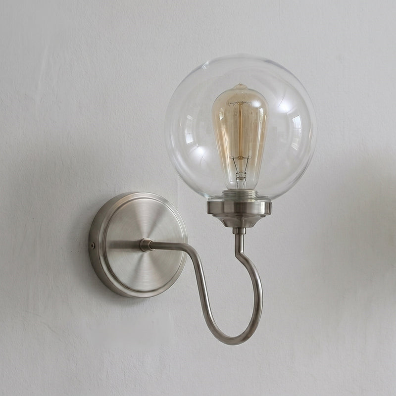 The soft glow from the Floren Wall Sconce with a white glass shade.