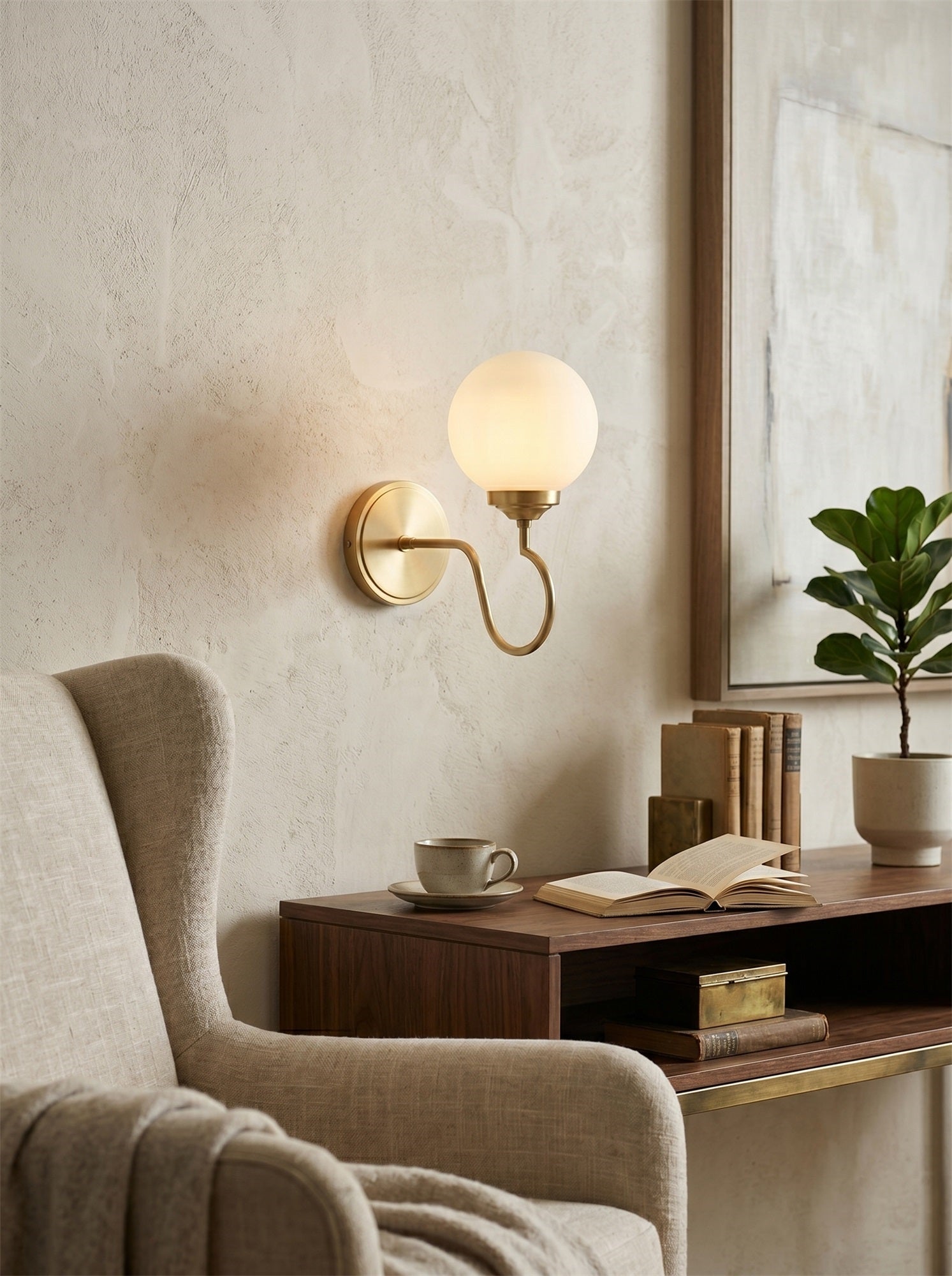 Floren Wall Sconce in a nickel finish, shown against a neutral wall.