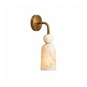 Flume Alabaster Arc Wall Sconce with a burnished brass arm against a neutral wall.