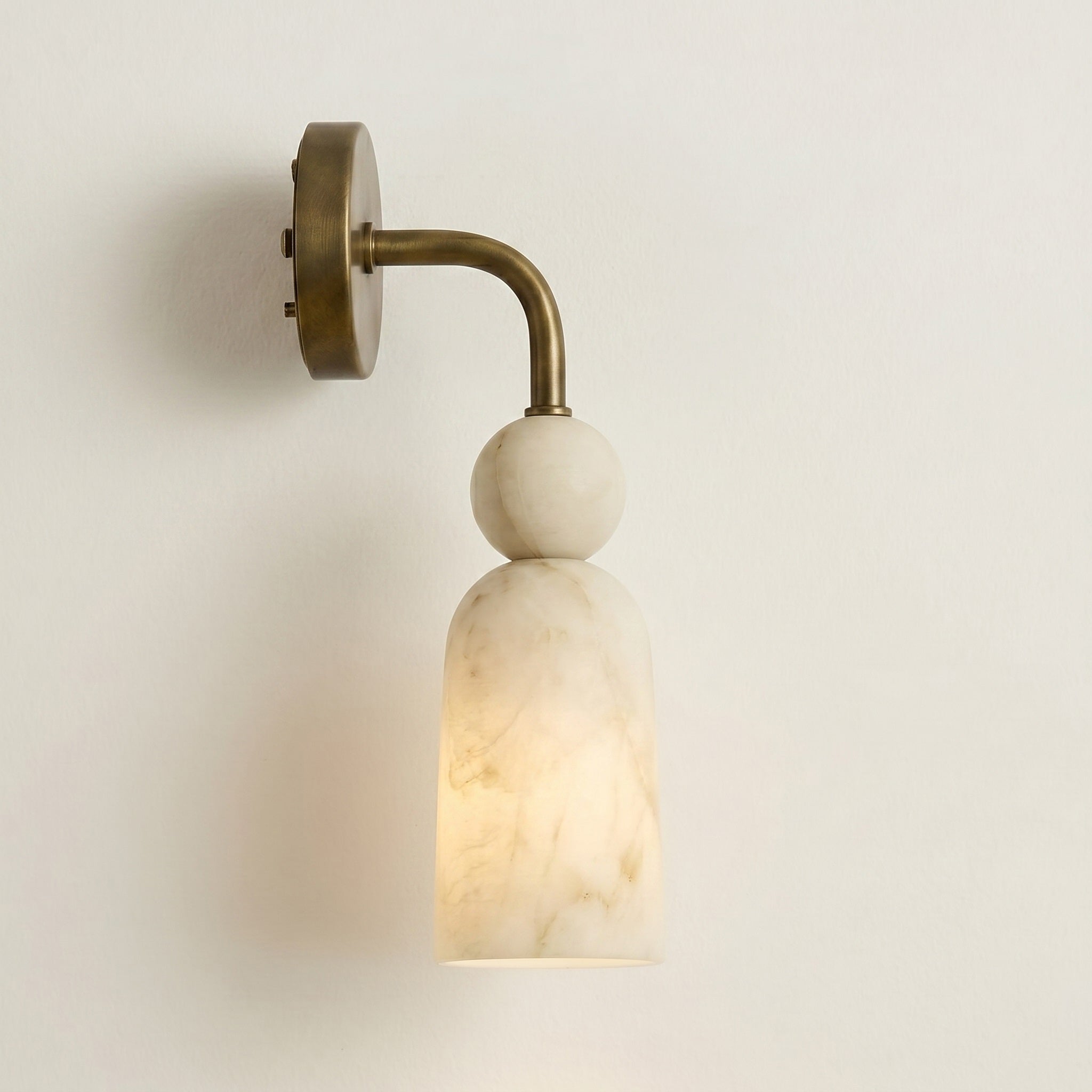 The unique, ethereal translucency of the alabaster shade when lit.
