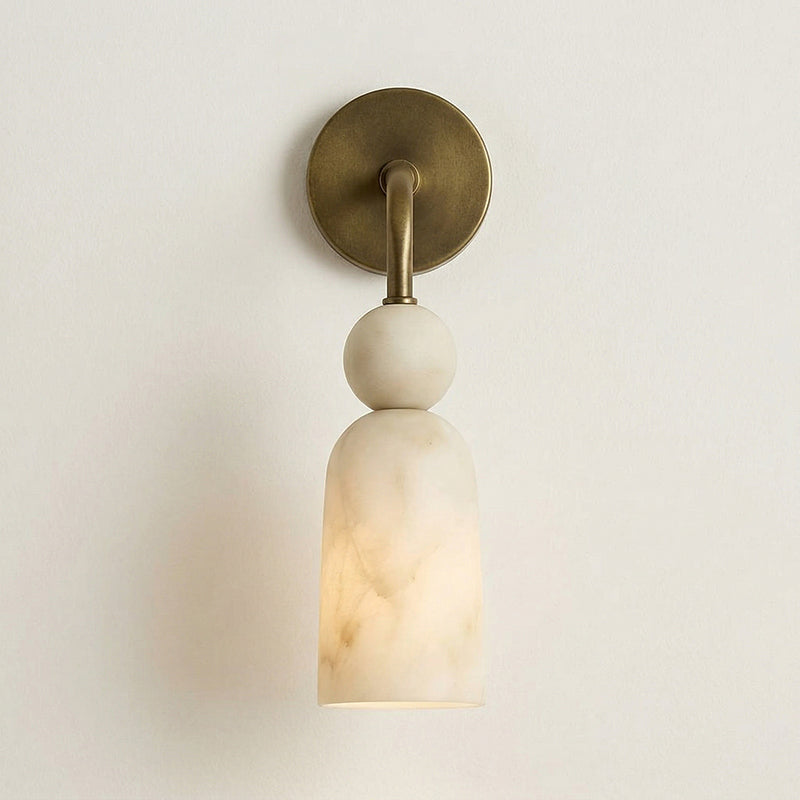 Lifestyle image of the sconce next to a piece of art.
