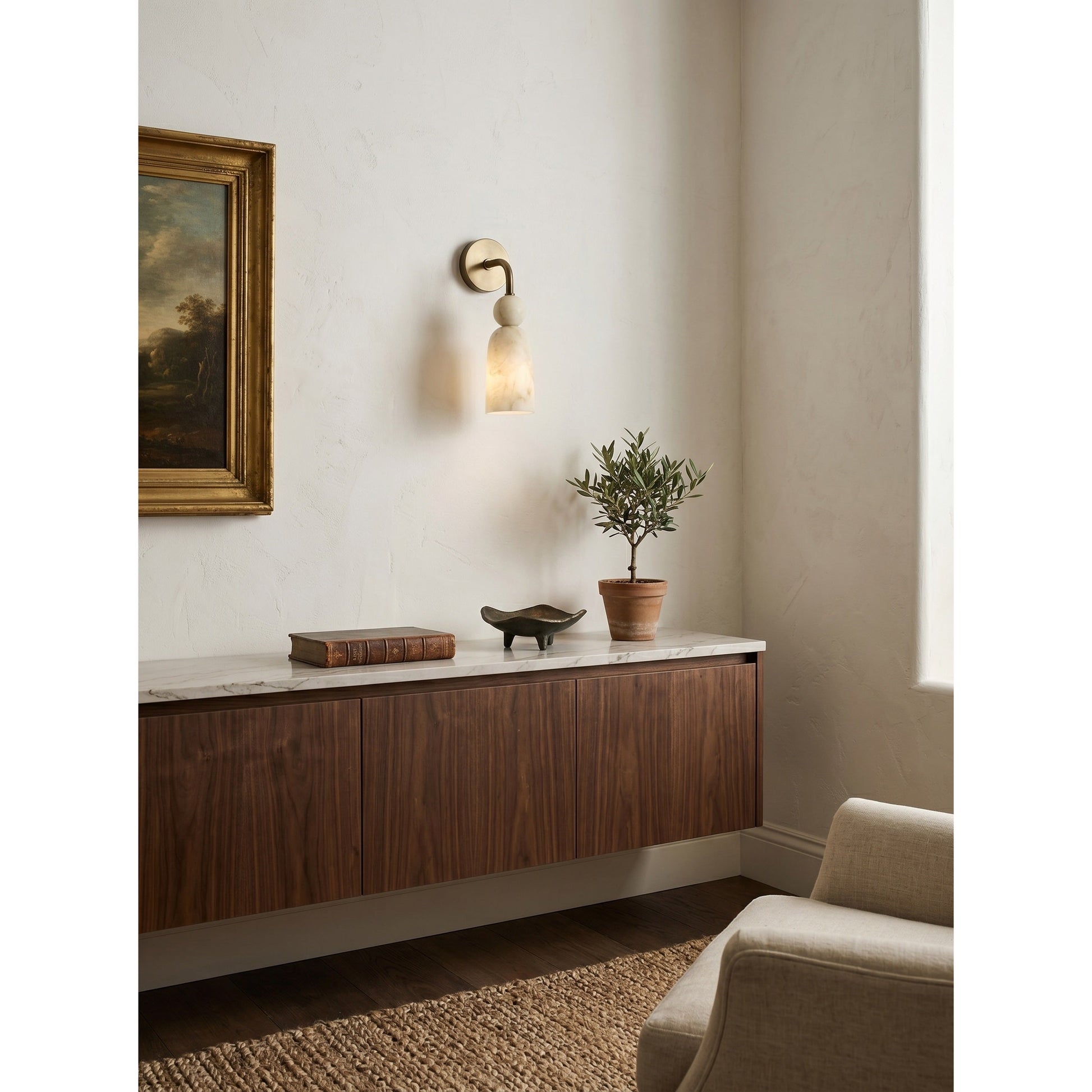 Front view of the alabaster and brass wall light.