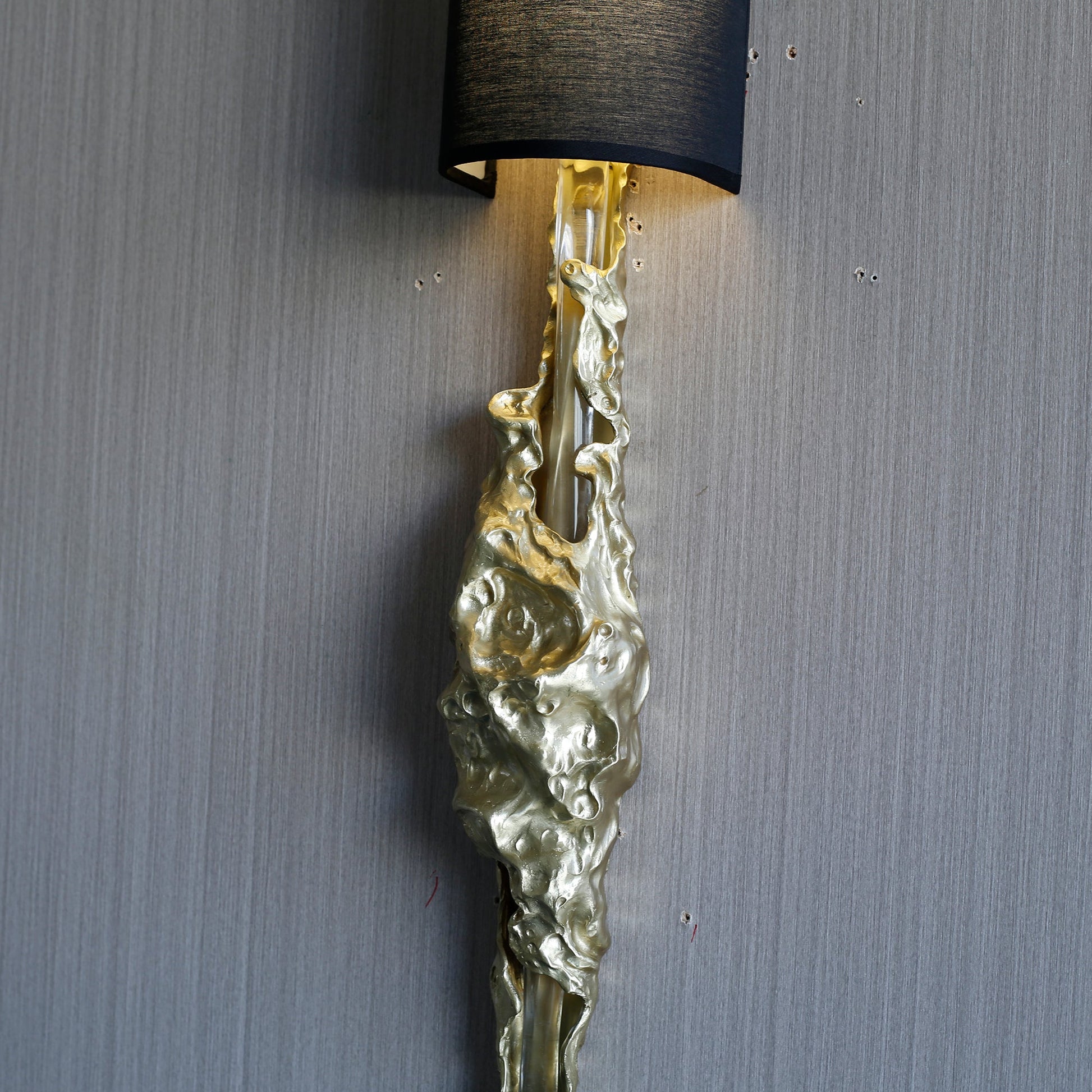 The Fusion Wall Sconce shown lit, demonstrating its sophisticated ambient glow.