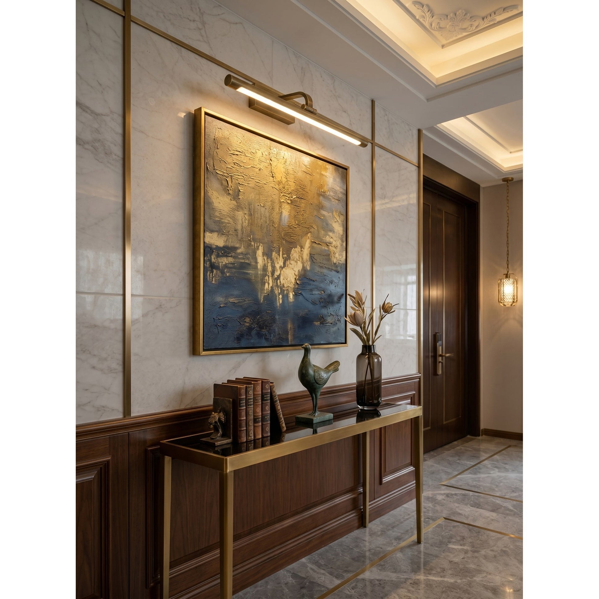 Goya Brass Wall Sconce mounted on a dark, moody wall.
