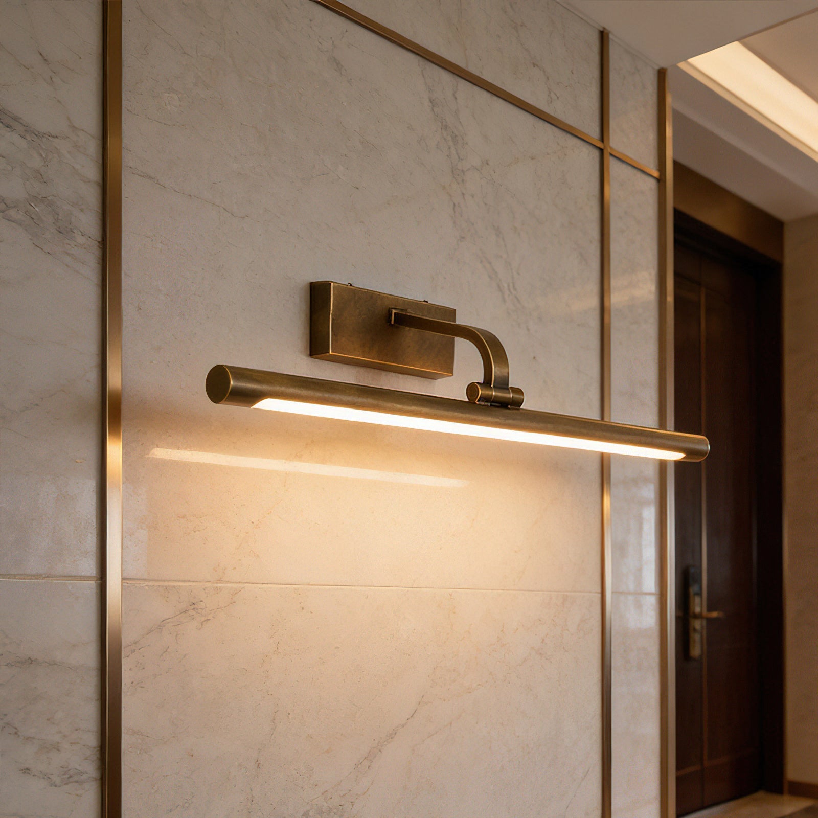 The warm glow of the Goya Brass Wall Sconce in a dark hallway.