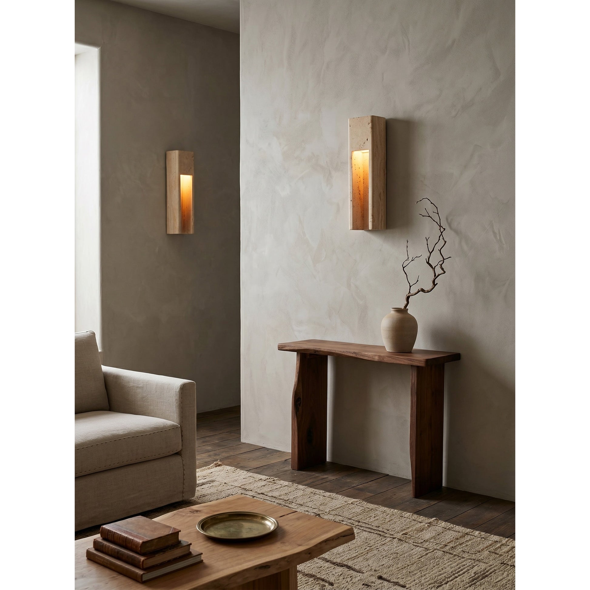 Graziano Travertine Wall Sconce used as bedside lighting in a minimalist bedroom.