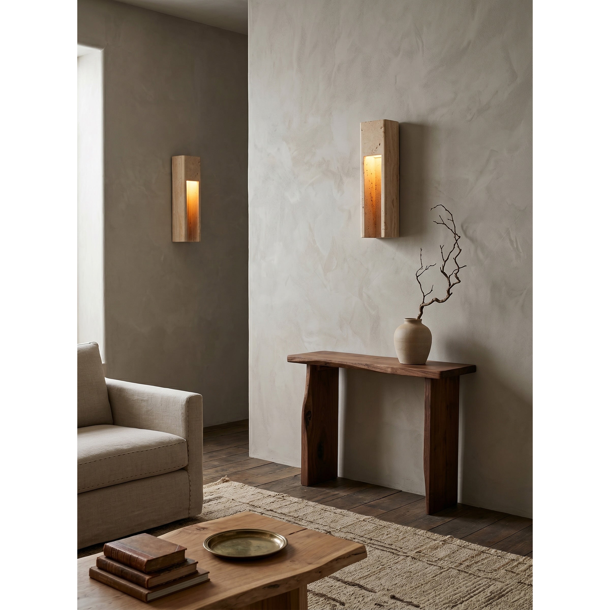 Graziano Travertine Wall Sconce used as bedside lighting in a minimalist bedroom.