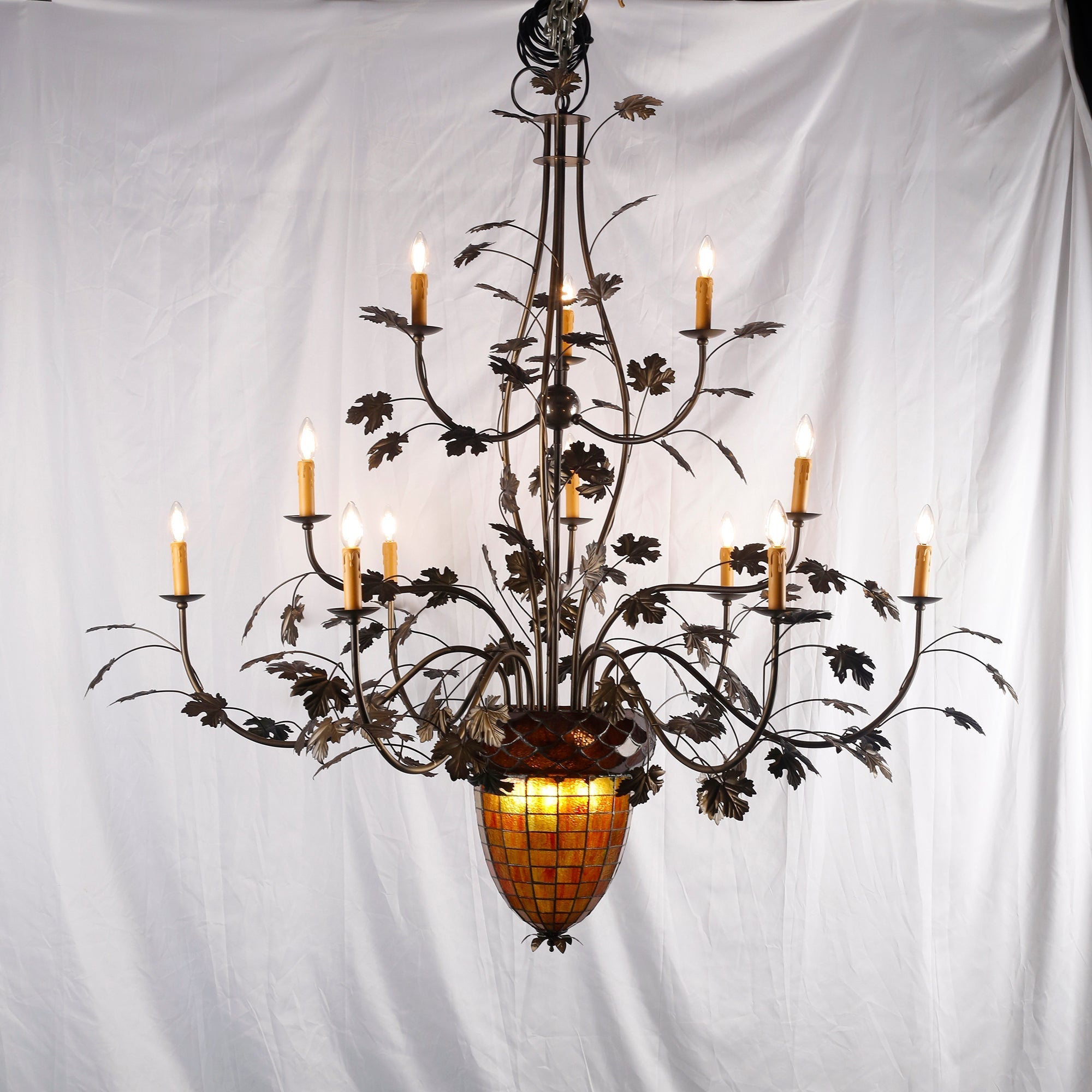 The chandelier with lights on, casting a warm glow.