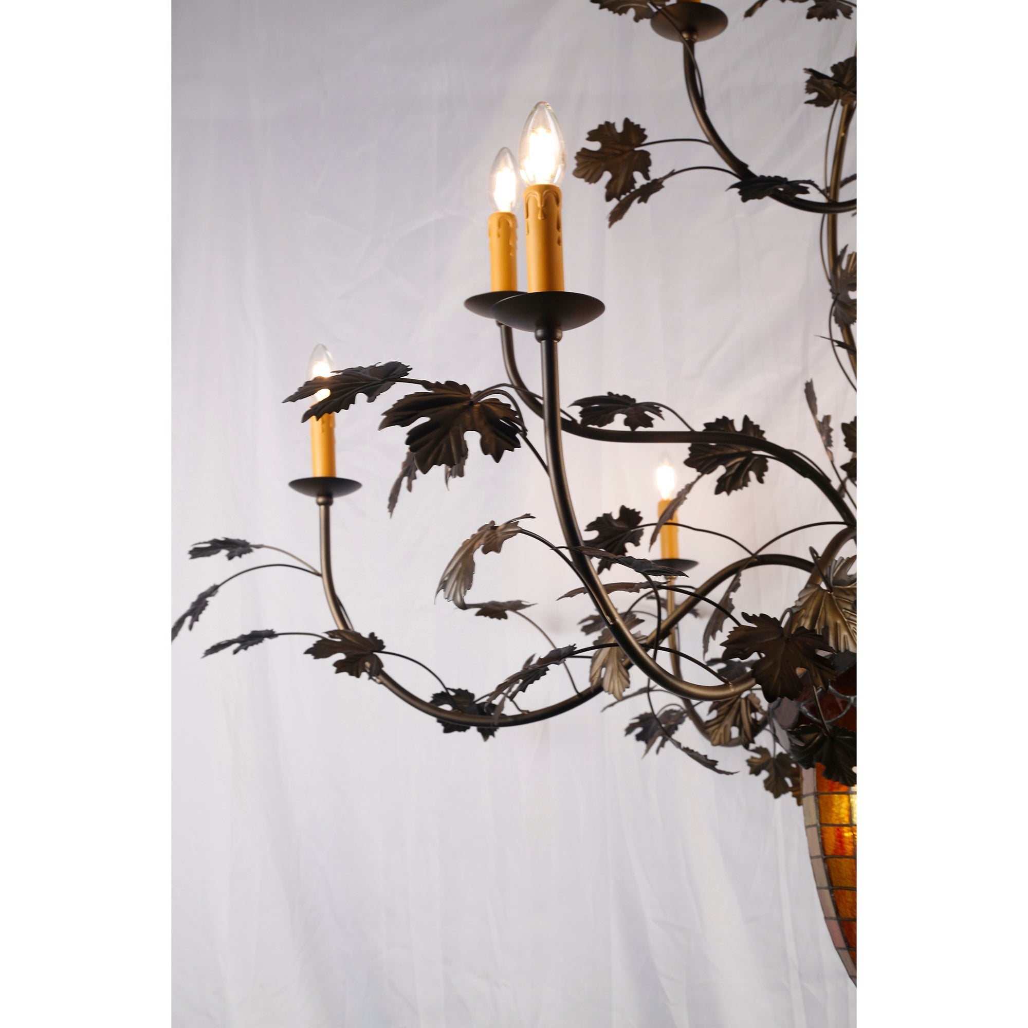 Lifestyle image showing the chandelier over a wooden table.