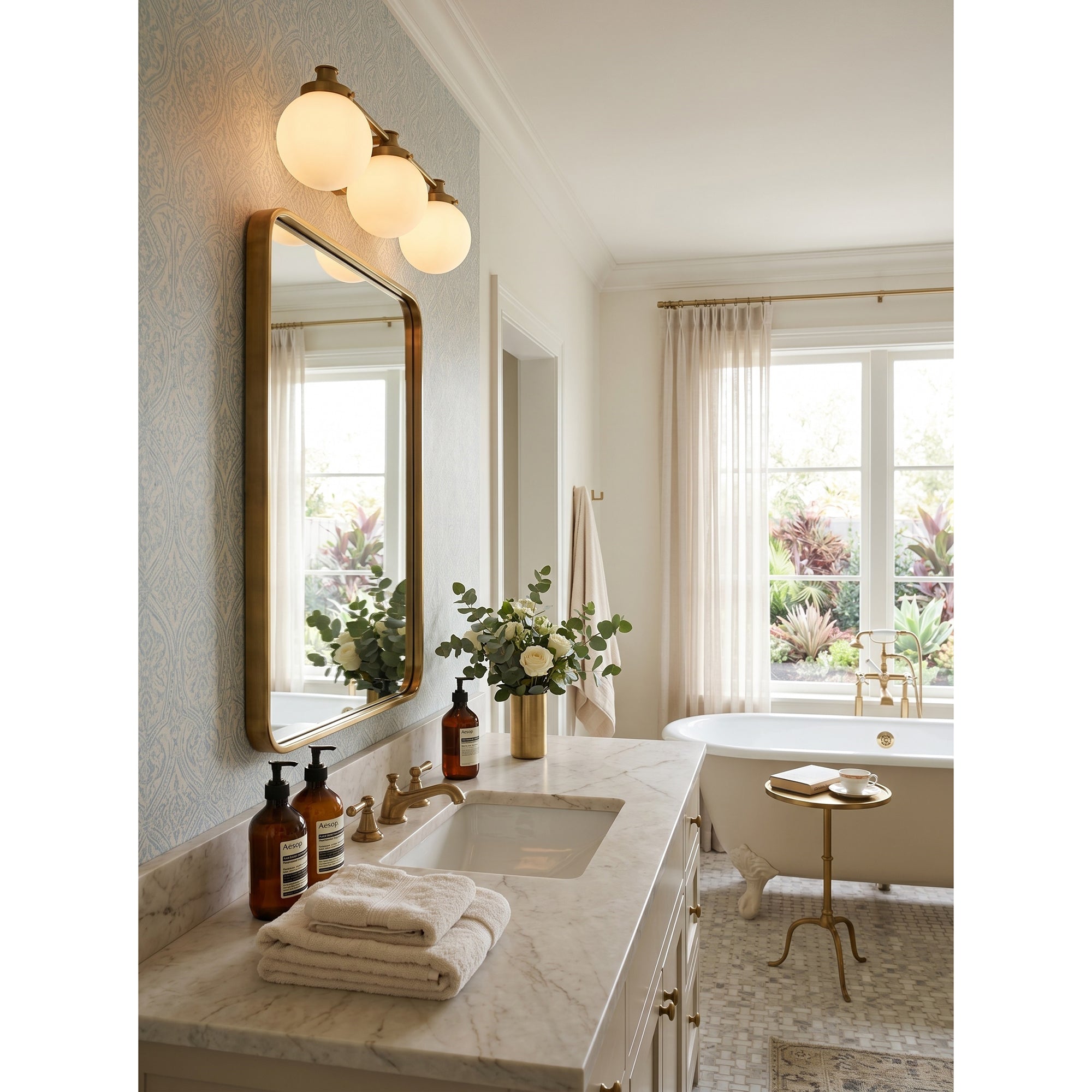 The 3-head Hayes sconce illuminating a master bathroom.