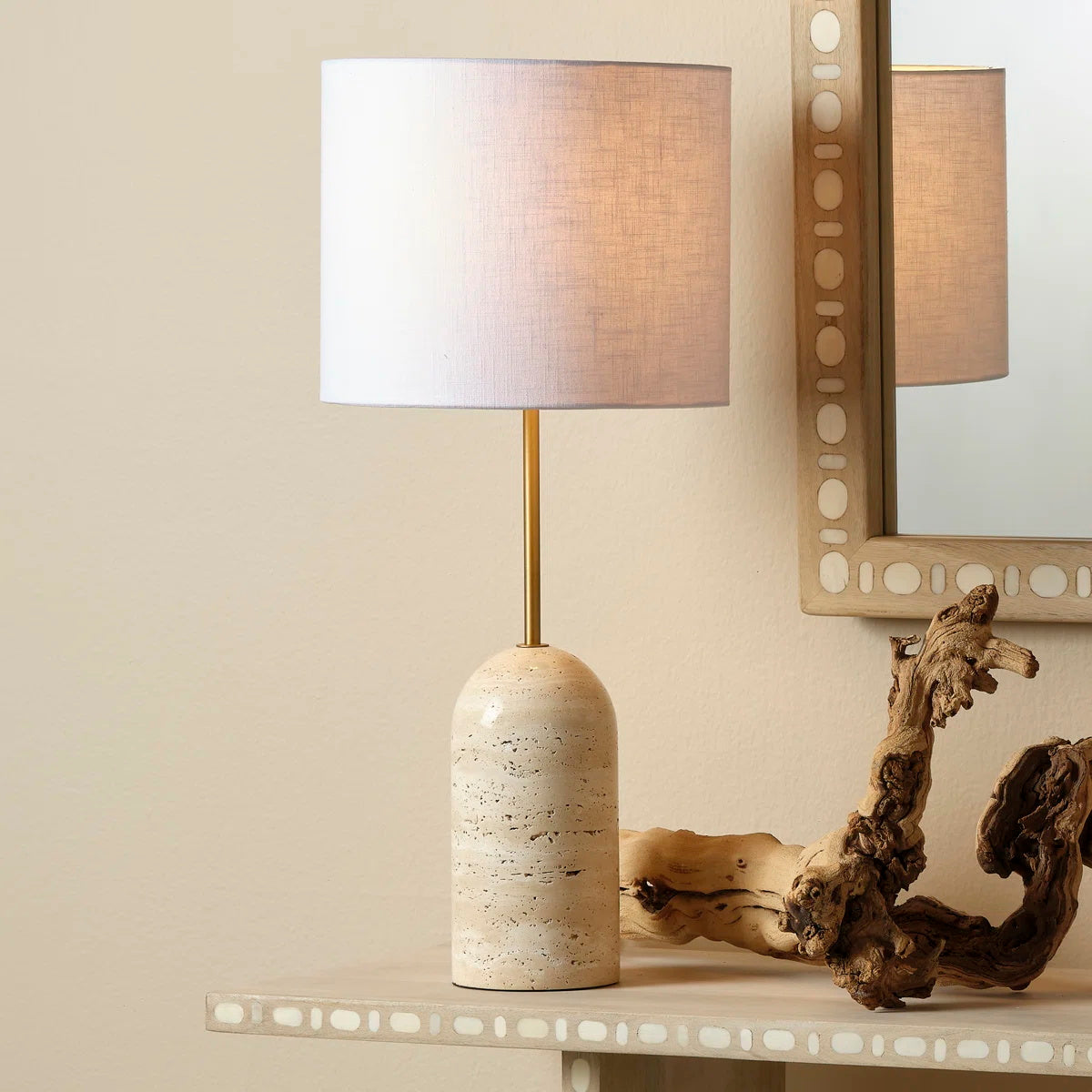 Side view of the Holt Table Lamp showing the travertine base and brass neck.