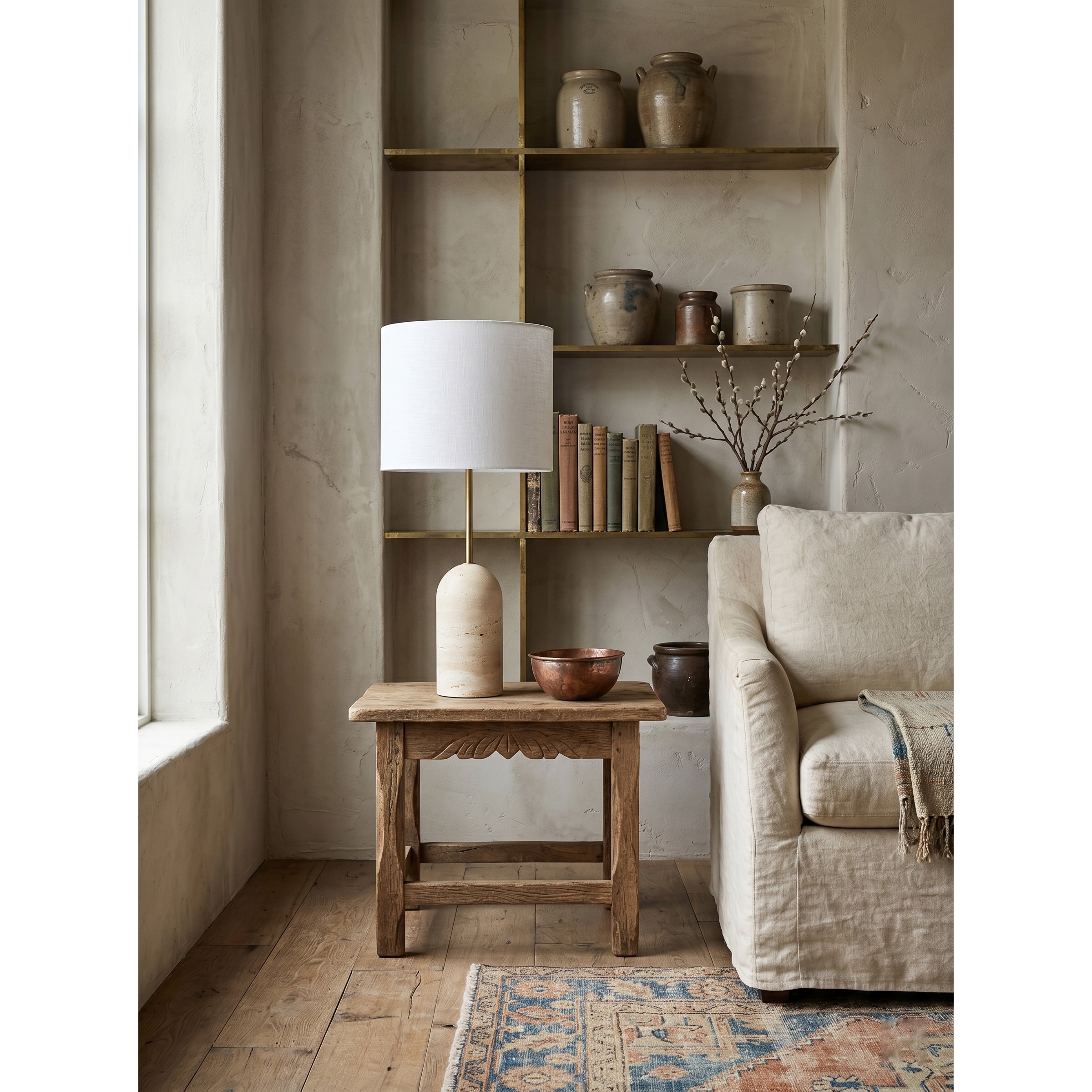 The lamp styled on a living room end table next to a sofa.