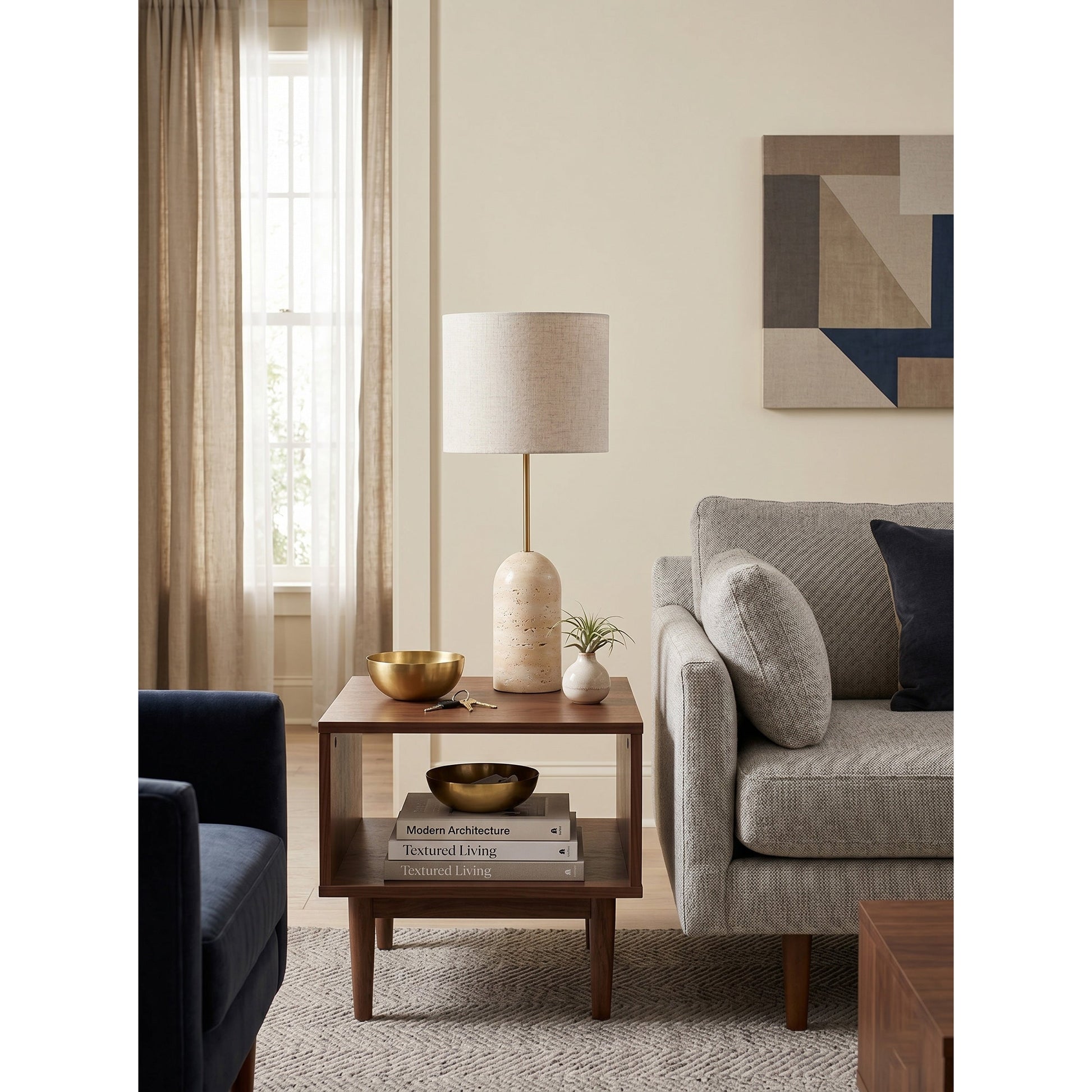 Holt Travertine Table Lamp placed on a bedroom nightstand.
