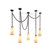 Industrial cascade chain alabaster chandelier hanging over a kitchen island.