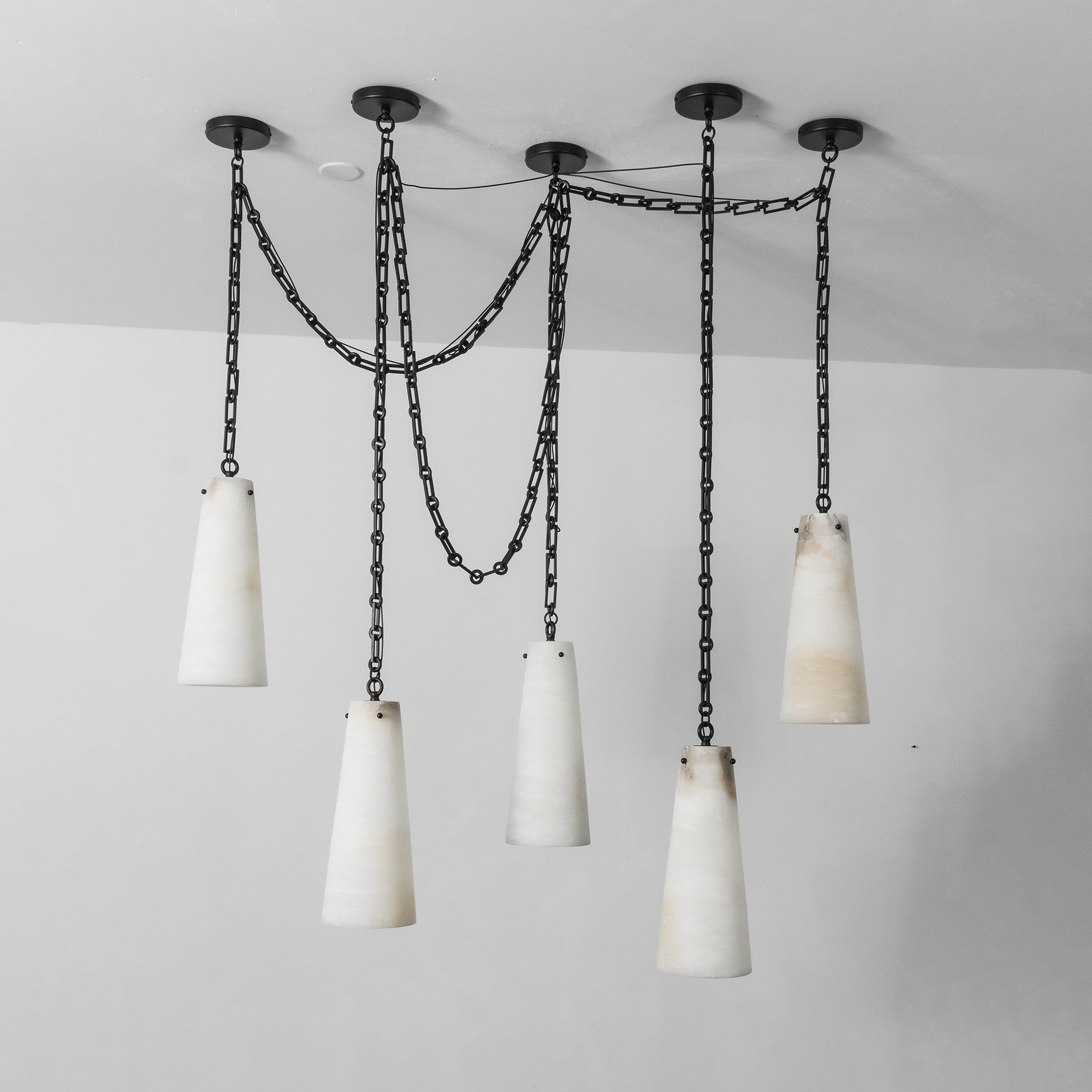 The industrial chandelier against a dark wall for contrast.