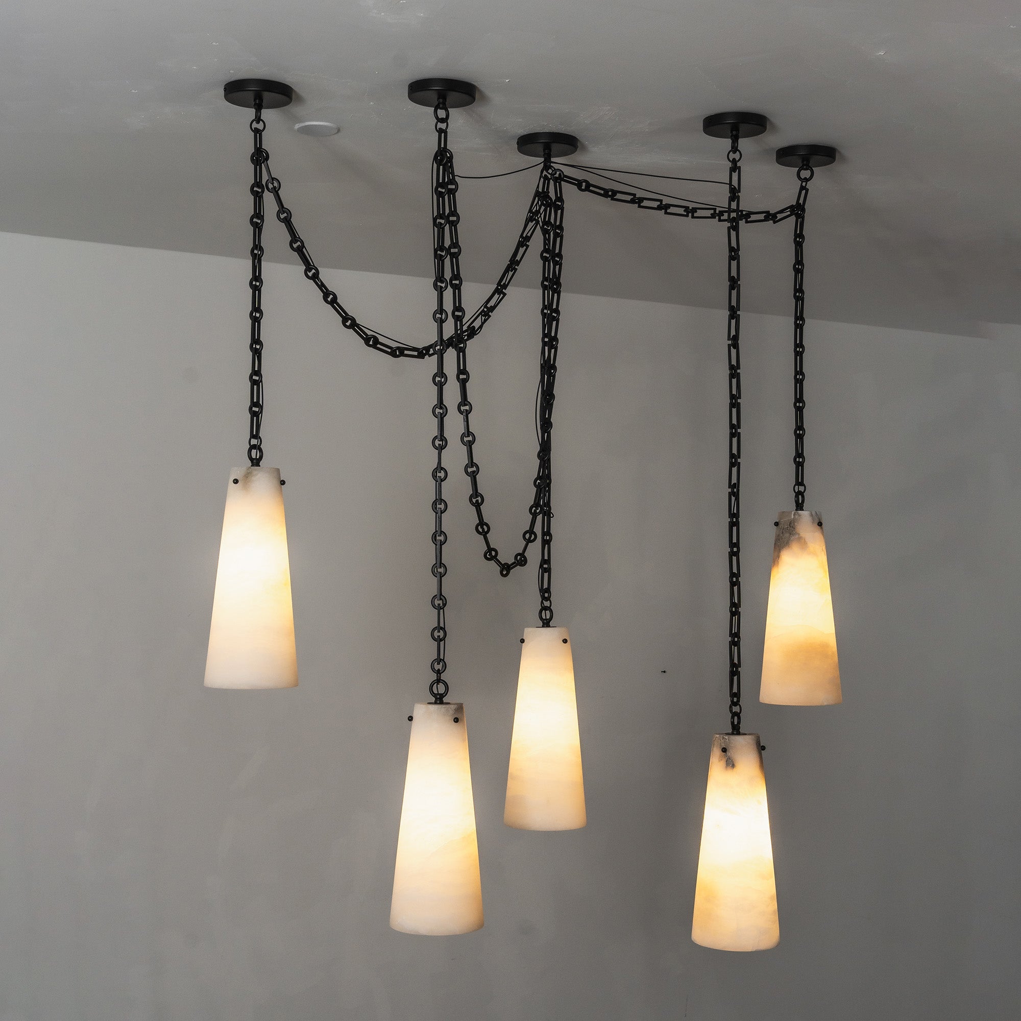 The chandelier providing functional light over a dining table.
