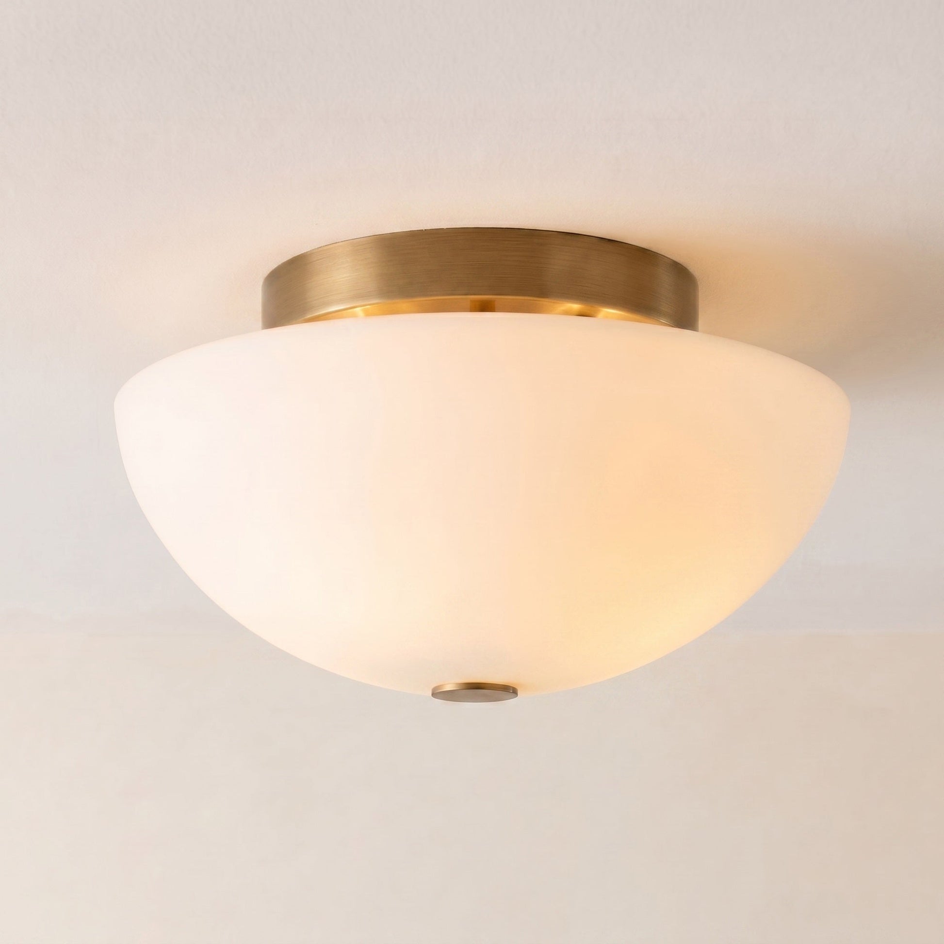 Jeanne flush mount with a matte black finish and white glass shade.