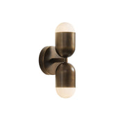 Jensen Wall Sconce in antique bronze finish against a neutral wall.