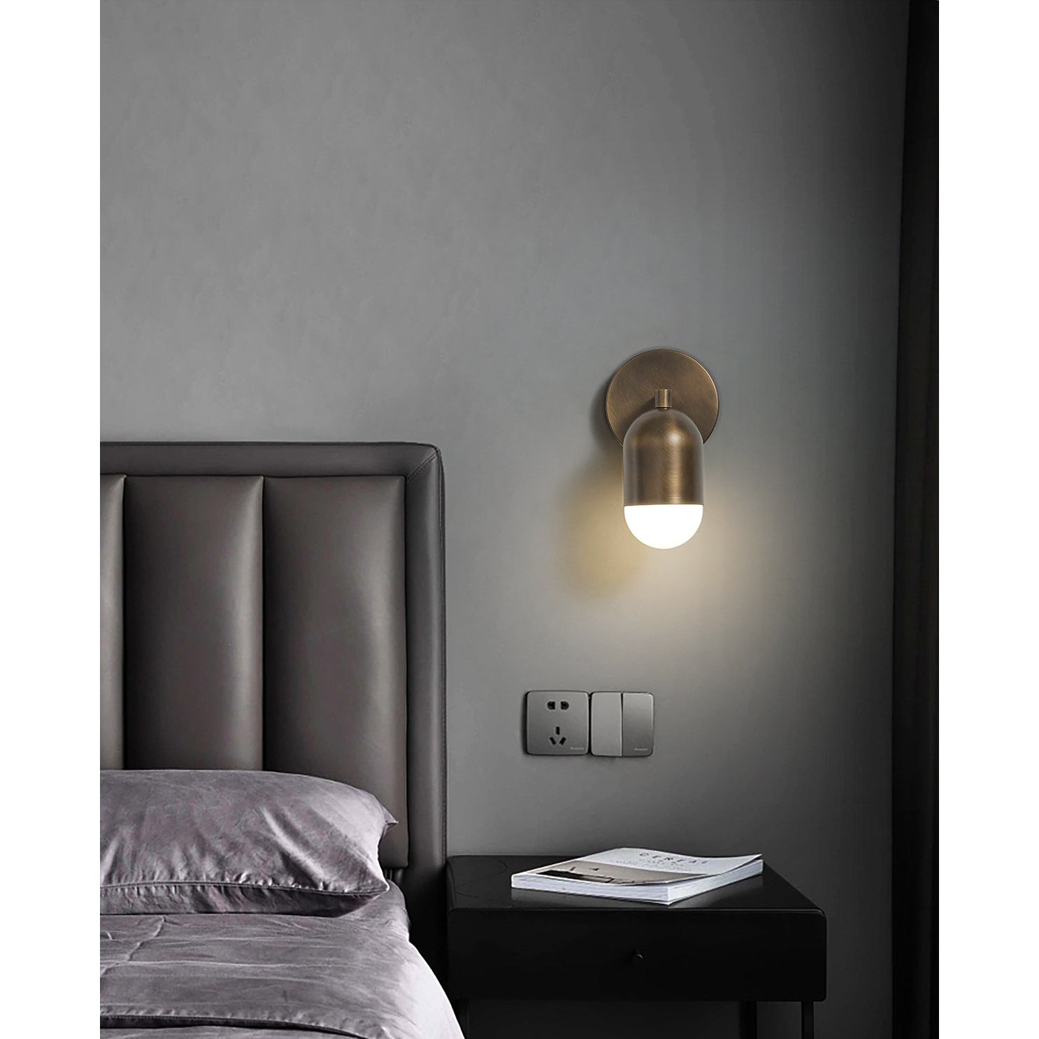 Jensen Wall Sconce in a dark, moody bathroom setting.