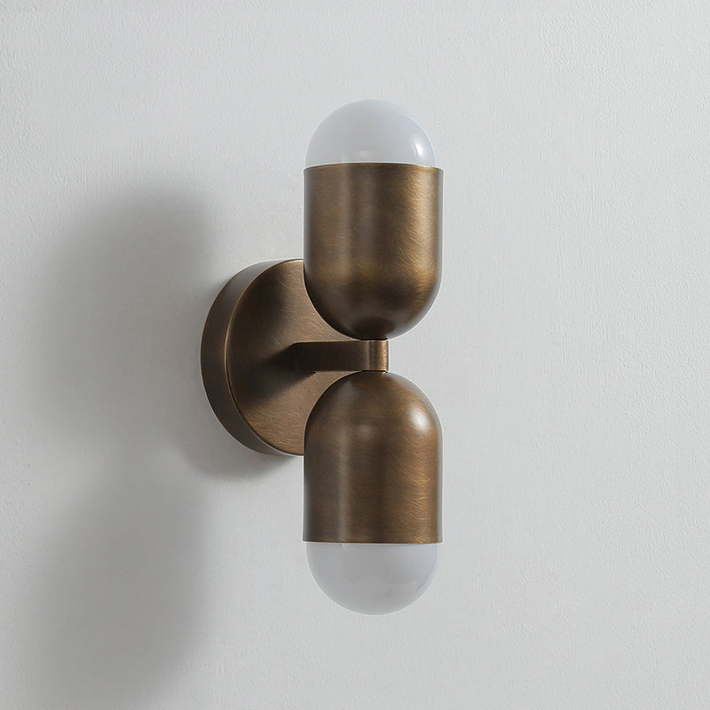 Jensen Wall Sconce against a textured wallpaper background.