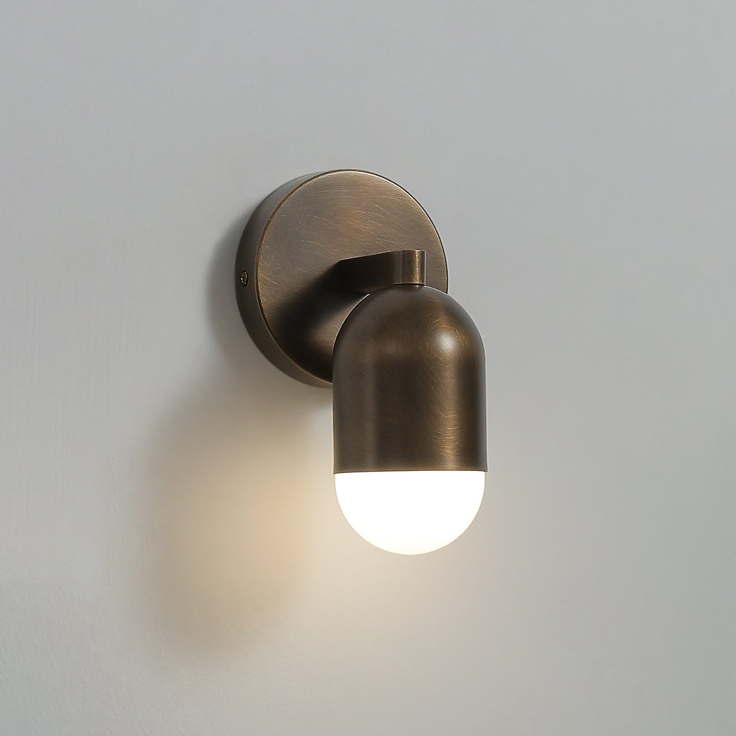 Upward glow from the top frosted glass shade of the Jensen Sconce.