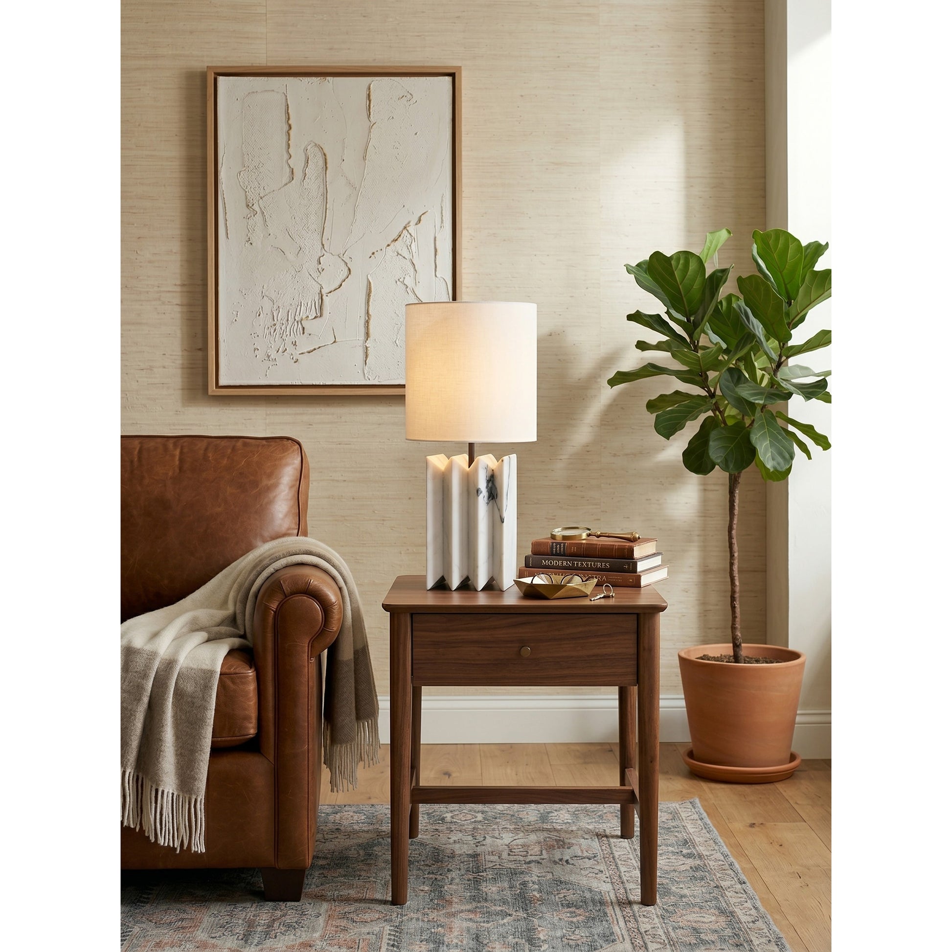 White marble version of the Jman Table Lamp against a dark, moody background.