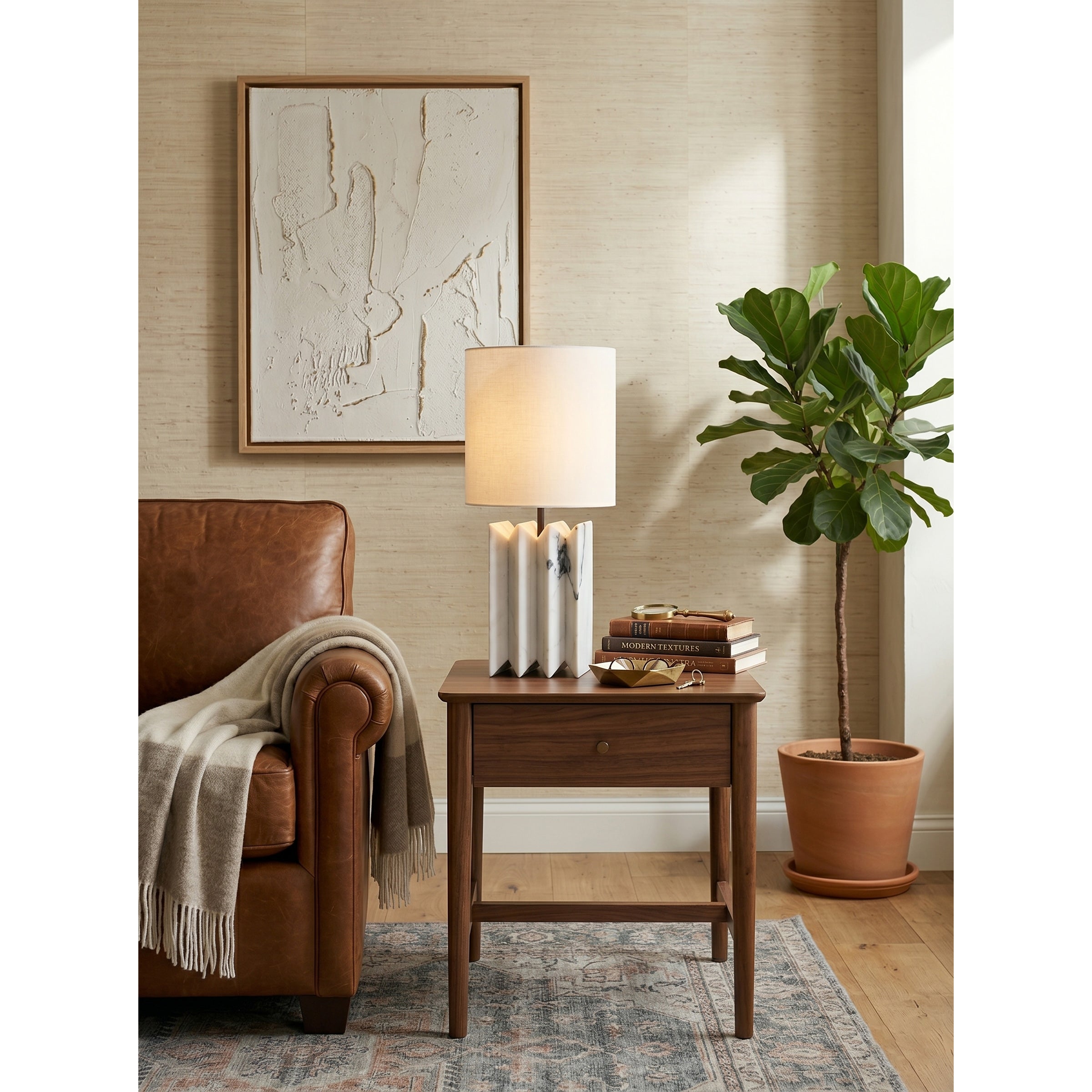 White marble version of the Jman Table Lamp against a dark, moody background.