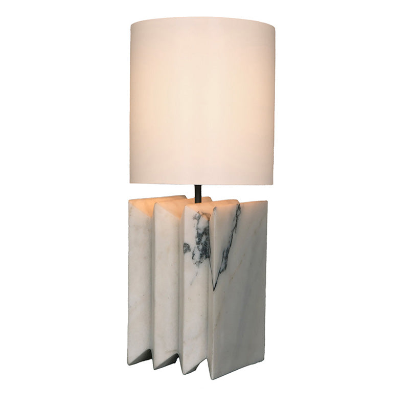 The warm, ambient glow diffused by the linen shade in a darkened room.