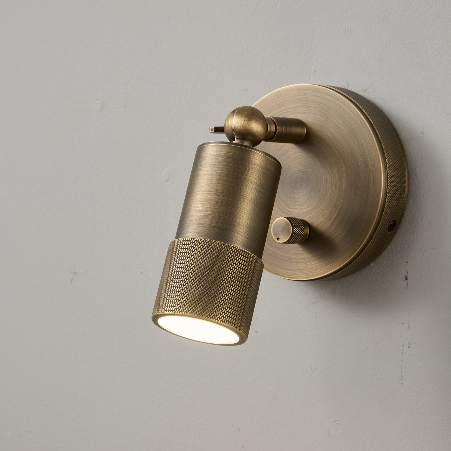 View of the circular backplate of the Jura Wall Sconce.