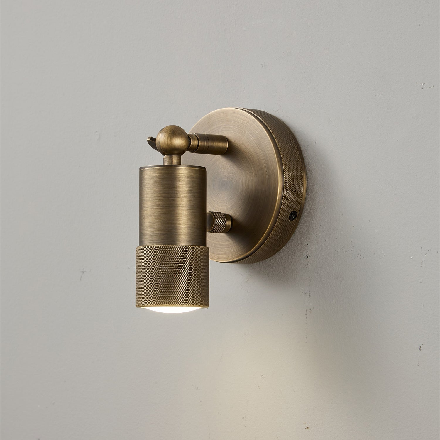 Jura Wall Sconce illuminating a piece of art on a gallery wall.