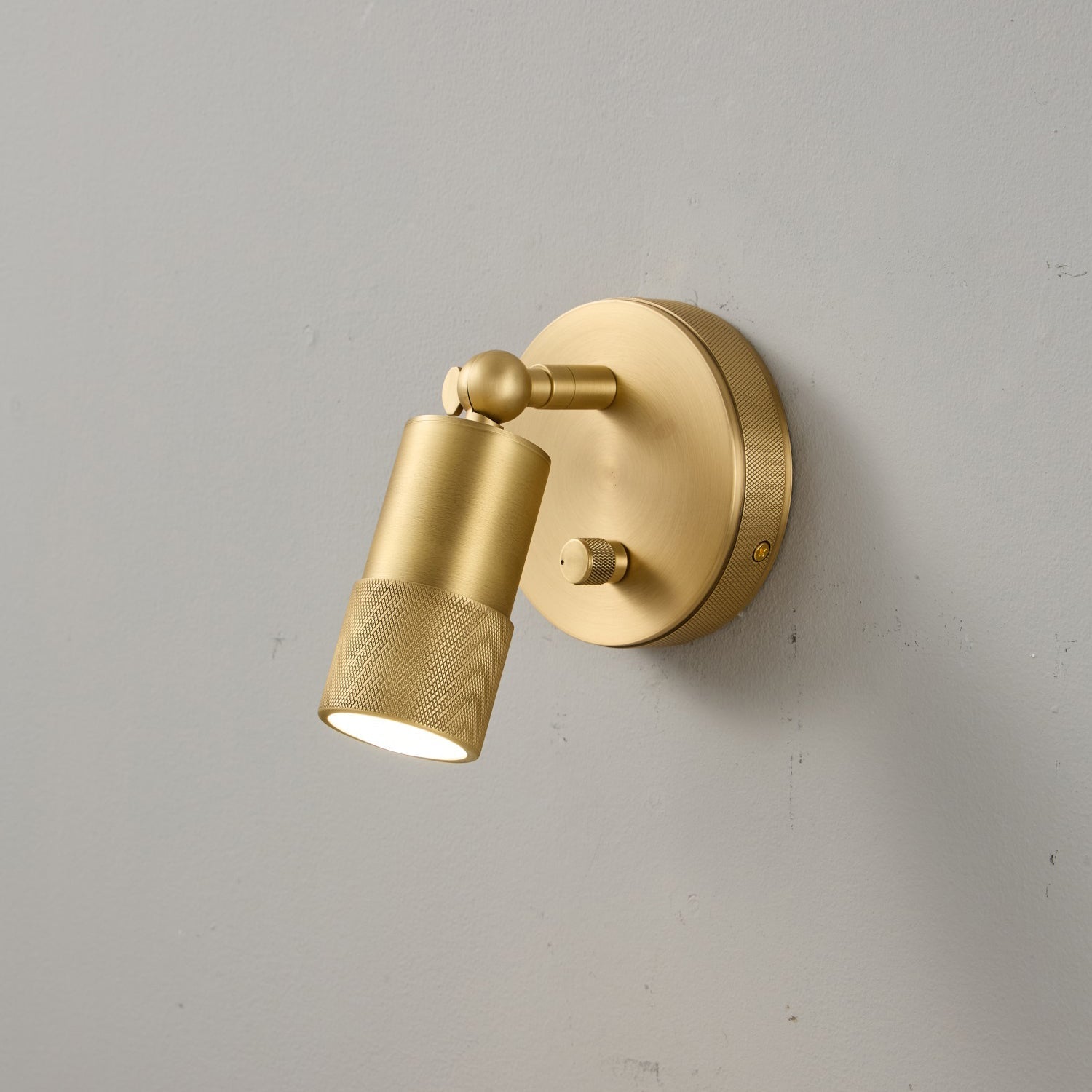 The Jura Wall Sconce casting a focused beam of light.