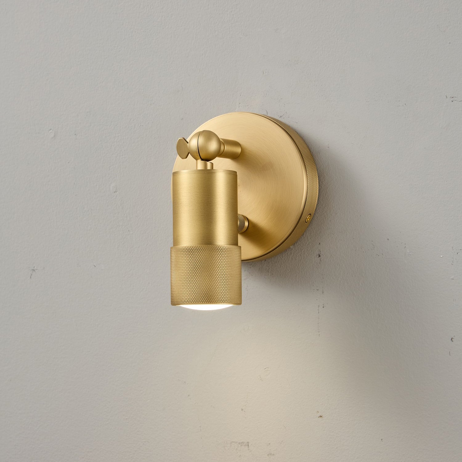 The sconce head tilted to direct light downwards.
