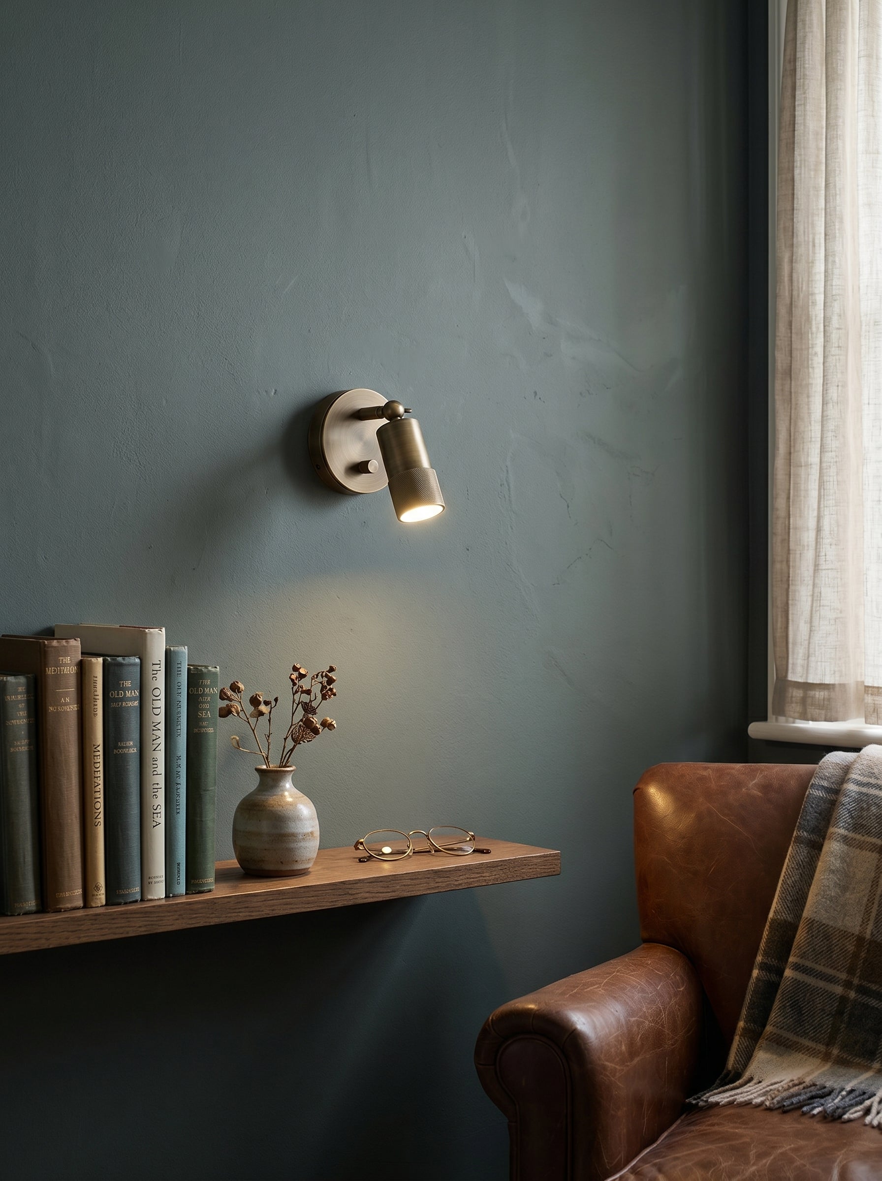 Jura Wall Sconce shown as a bedside reading light.