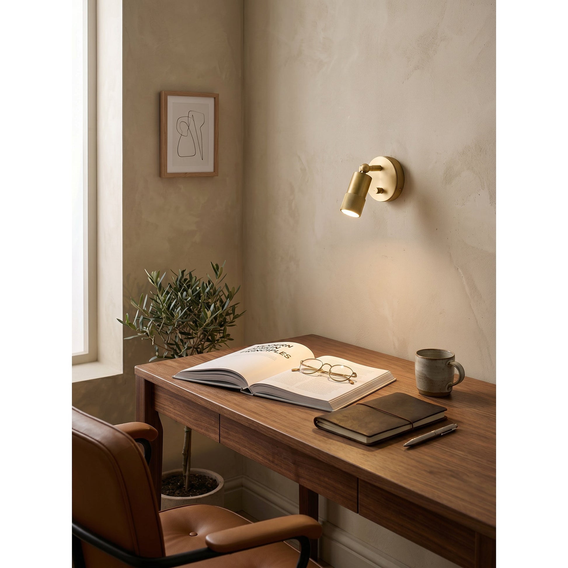 Front view of the Jura Wall Sconce against a white wall.