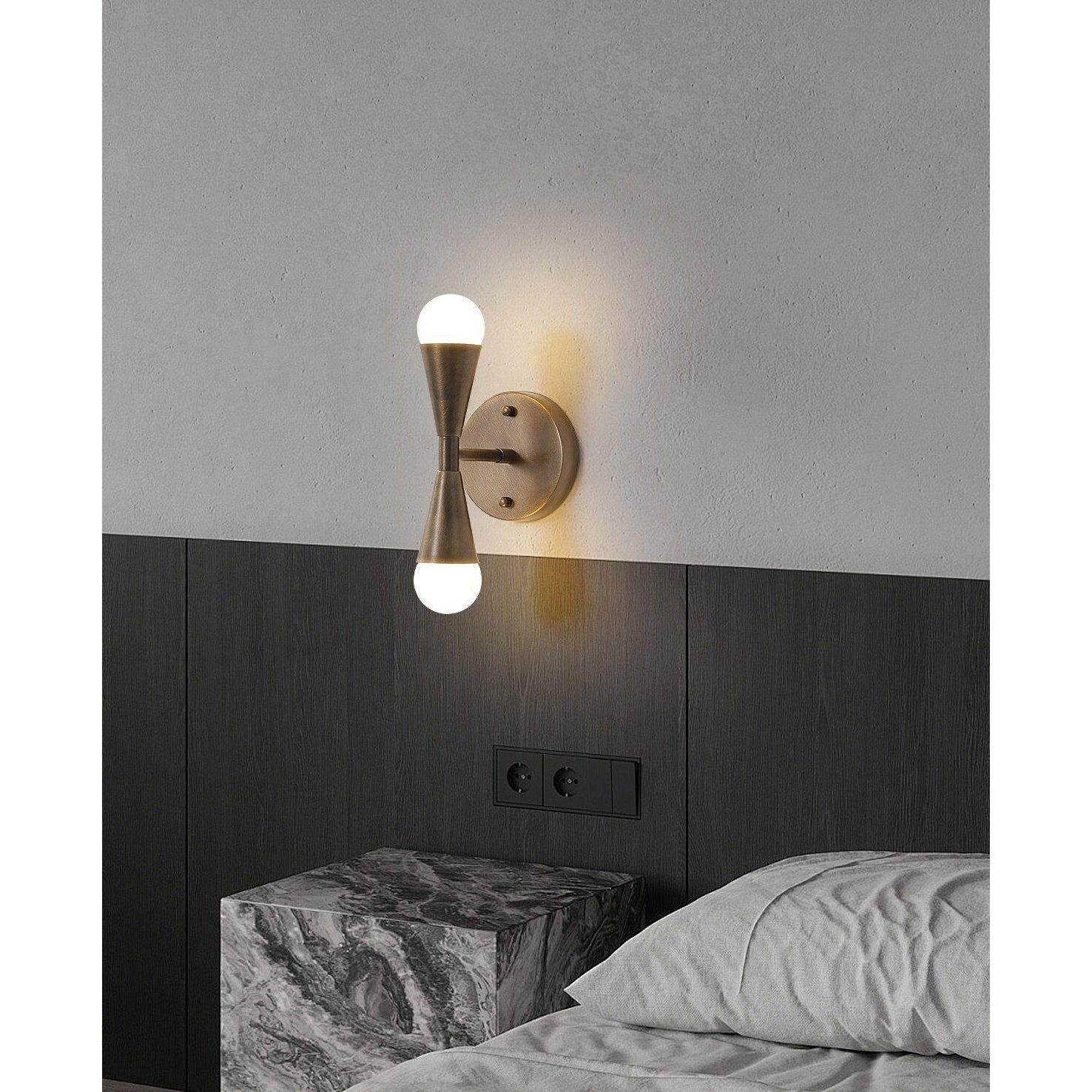 The sculptural, minimalist silhouette of the Karma Double Wall Sconce.