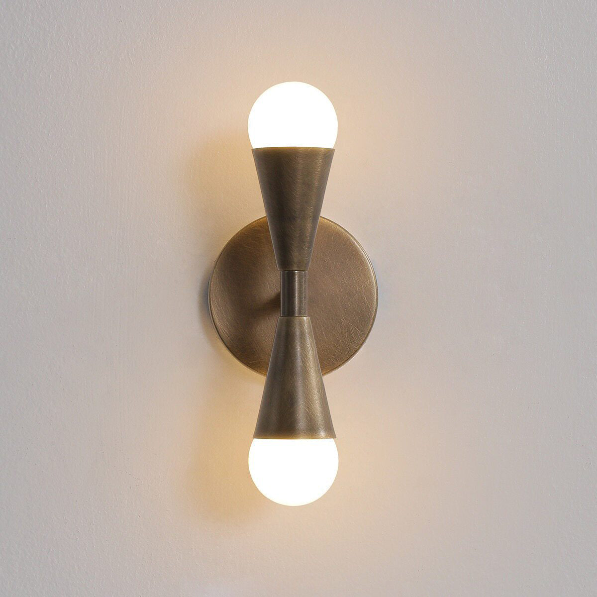 Lifestyle image showing the Karma Sconce in an urban loft interior.