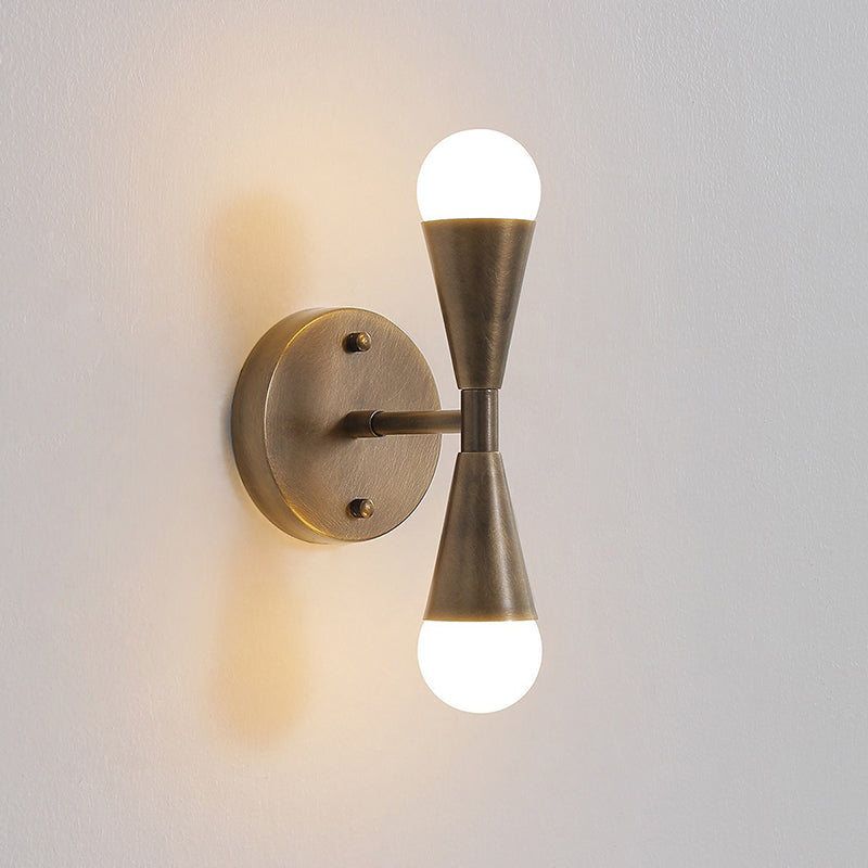 The circular backplate of the Karma Wall Sconce.