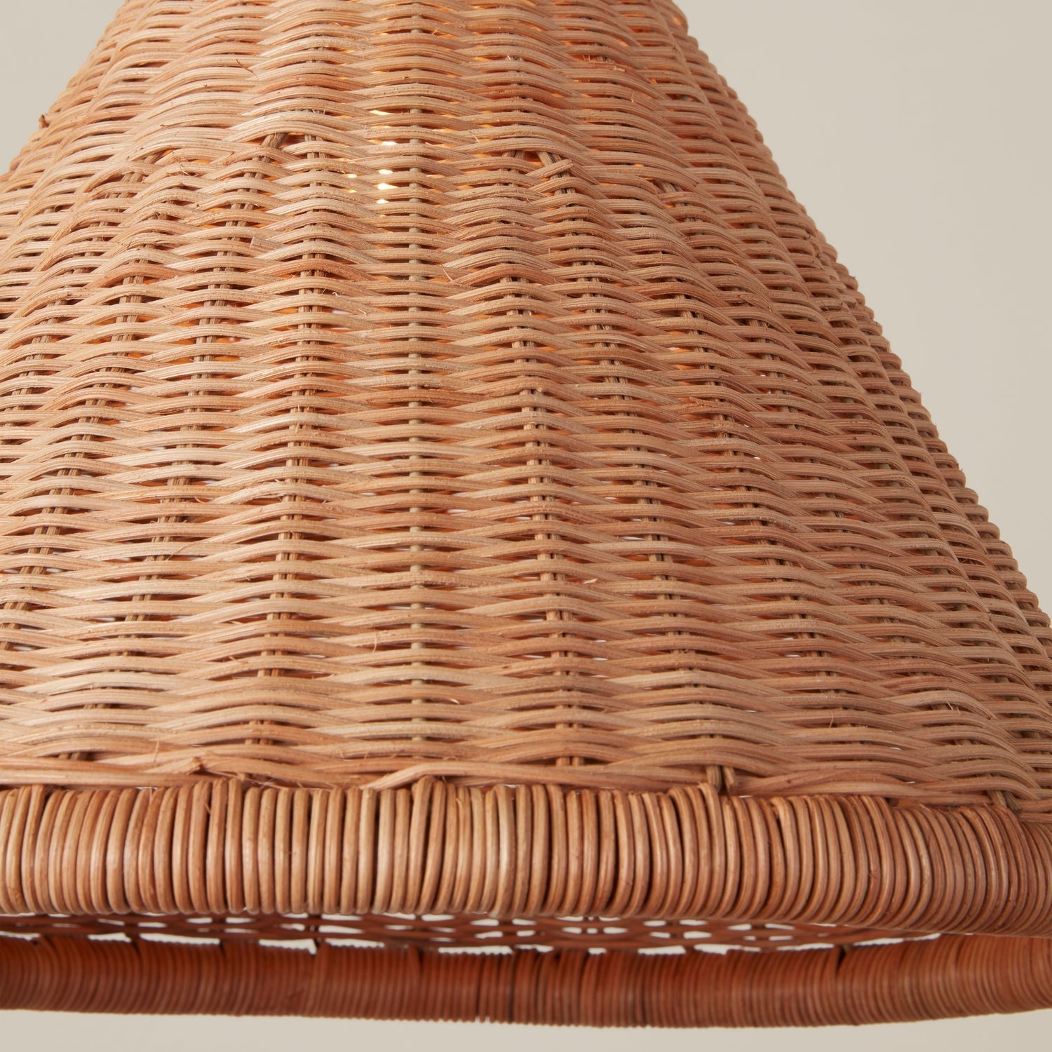 Lifestyle image featuring the rattan pendant in a sunlit room.